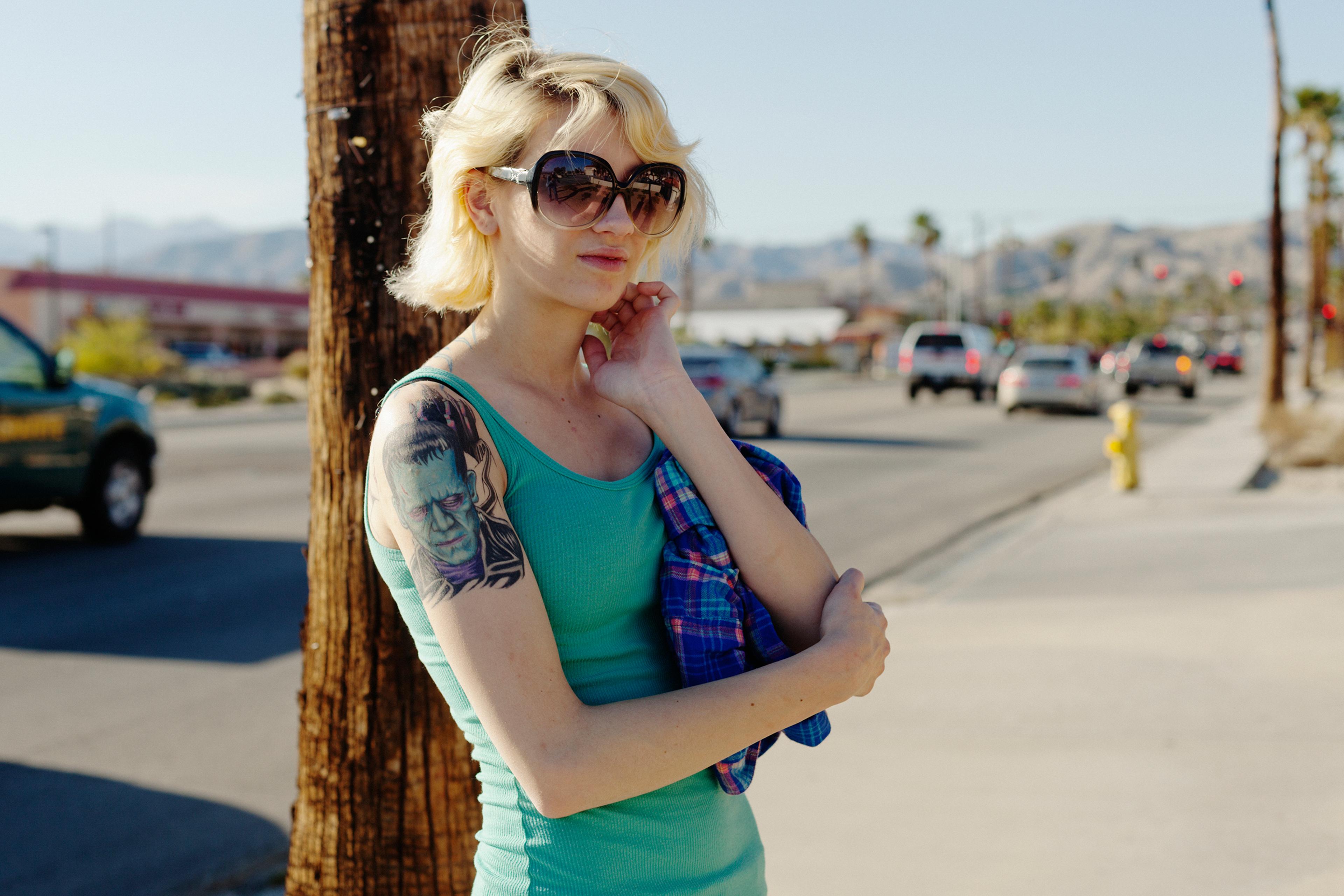 San Andreas Fault, California: Desert Hot Springs. Not many people are seen on the pavement in Desert Hot Springs. After just a few seconds of photographing this girl a car came down the street, the driver shouting at me: Get in your car! The girl angril