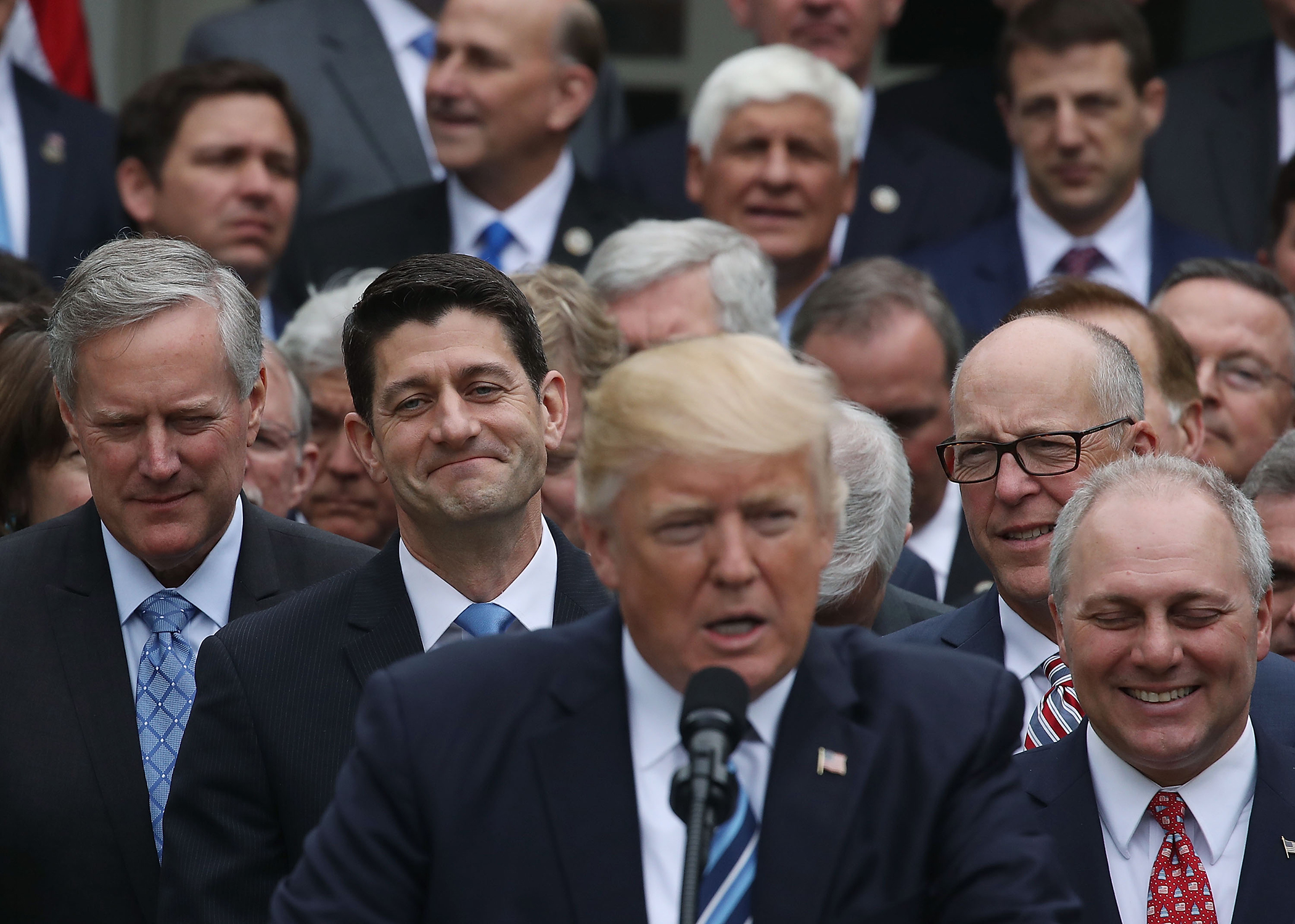 House Speaker Paul Ryan (R-WI) (2nd-L) listens as U.S. President Donald Trump congratulates House Republicans after they passed legislation aimed at repealing and replacing ObamaCare, during an event in the Rose Garden at the White House, on May 4, 2017 