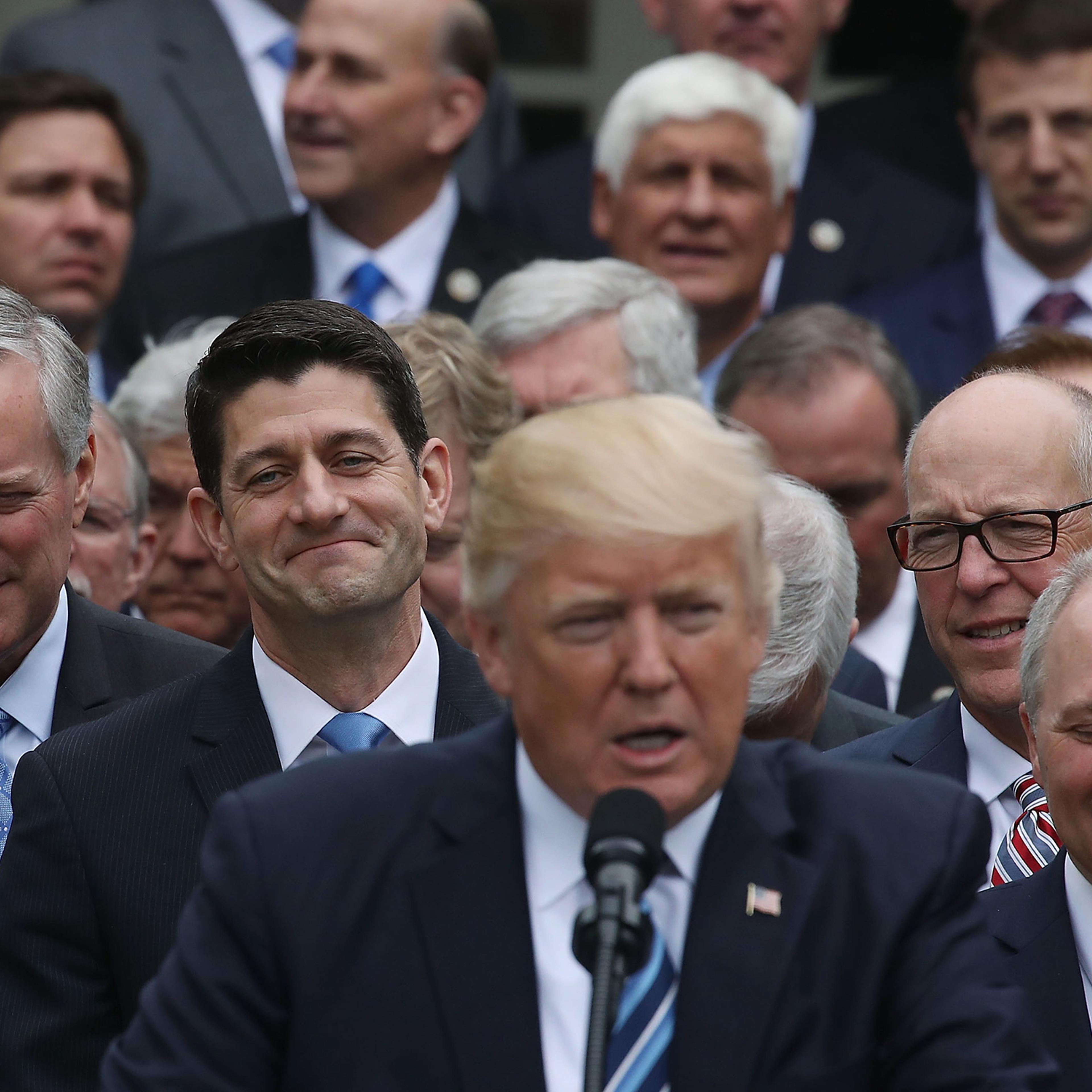 House Speaker Paul Ryan (R-WI) (2nd-L) listens as U.S. President Donald Trump congratulates House Republicans after they passed legislation aimed at repealing and replacing ObamaCare, during an event in the Rose Garden at the White House, on May 4, 2017