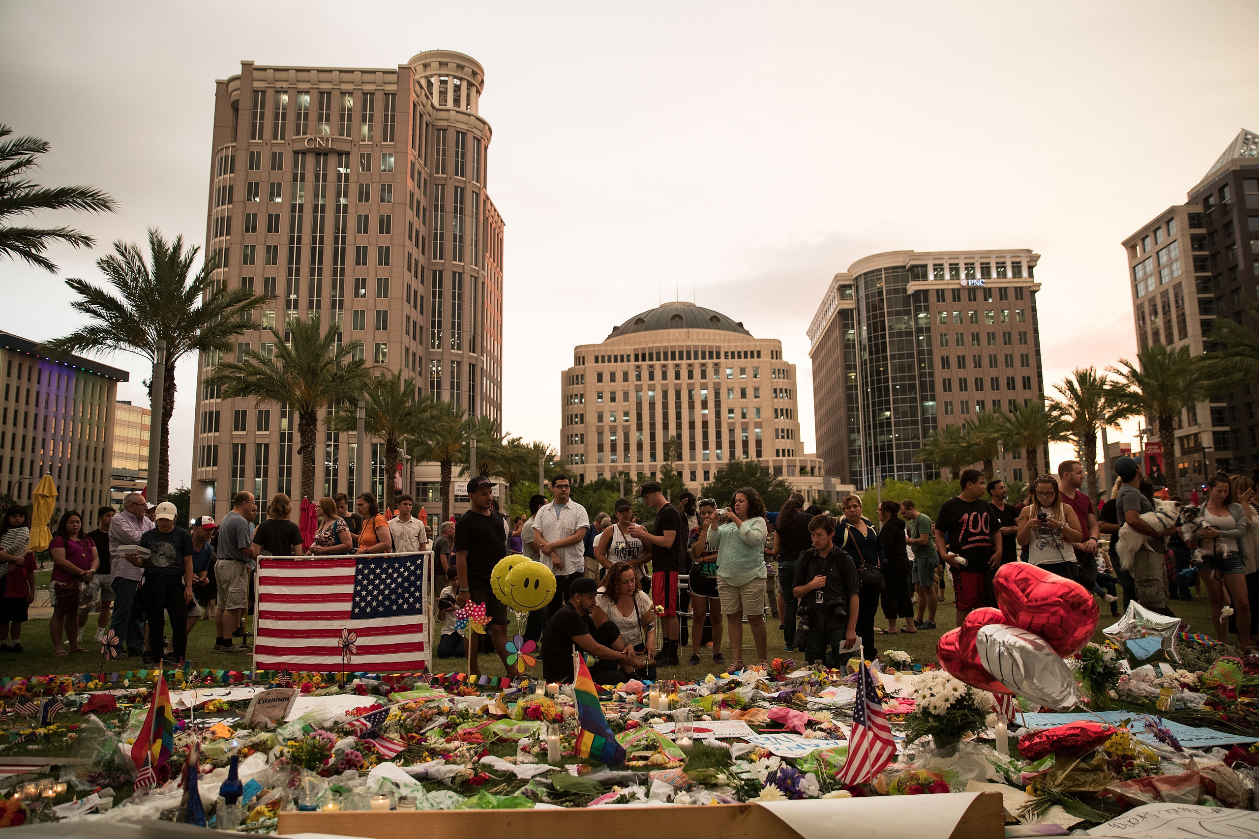 People visit a memorial for the victims of the Pulse Nightclub shooting, at the Dr. Phillips Center for Performing Arts in Orlando on June 14, 2016.