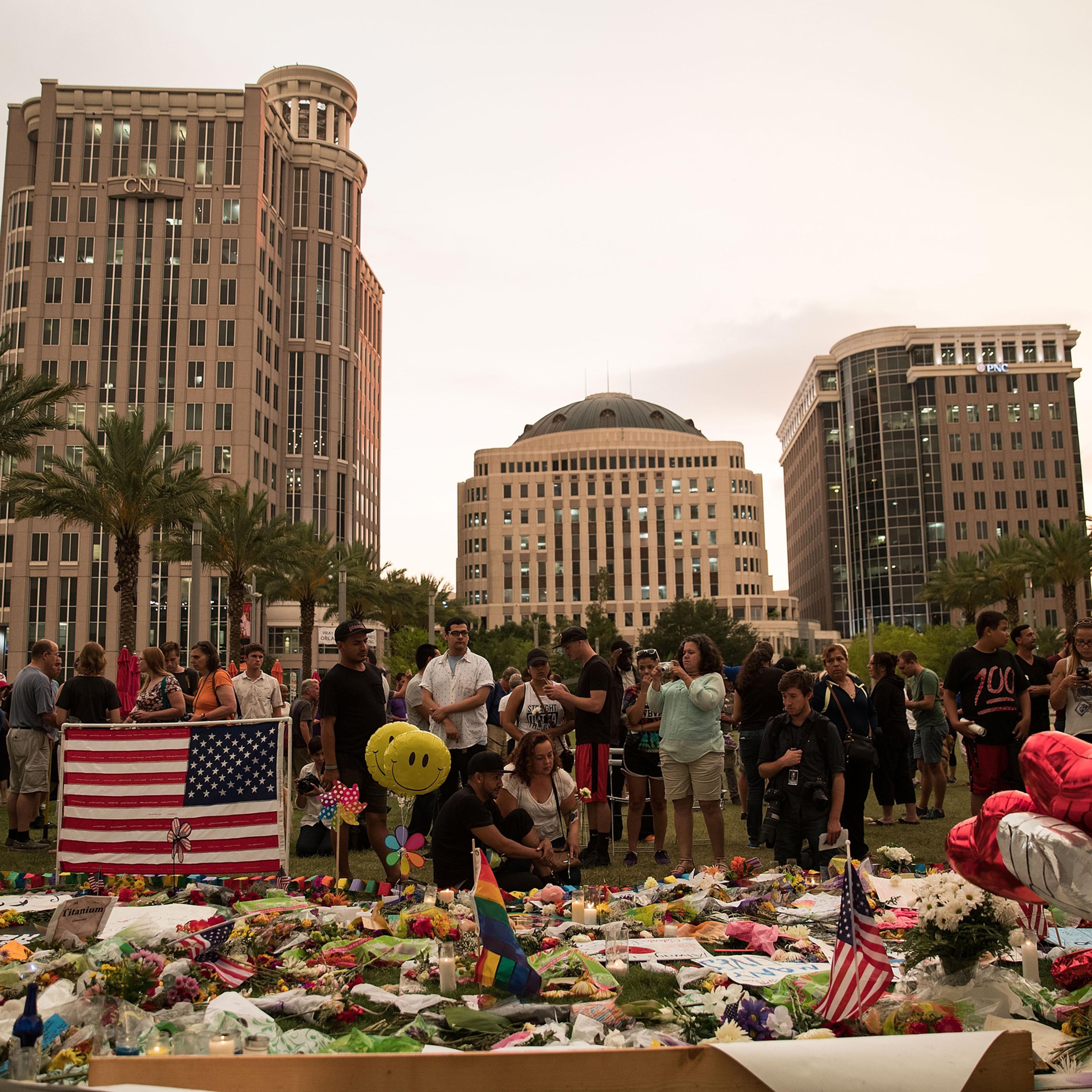People visit a memorial for the victims of the Pulse Nightclub shooting, at the Dr. Phillips Center for Performing Arts in Orlando on June 14, 2016.