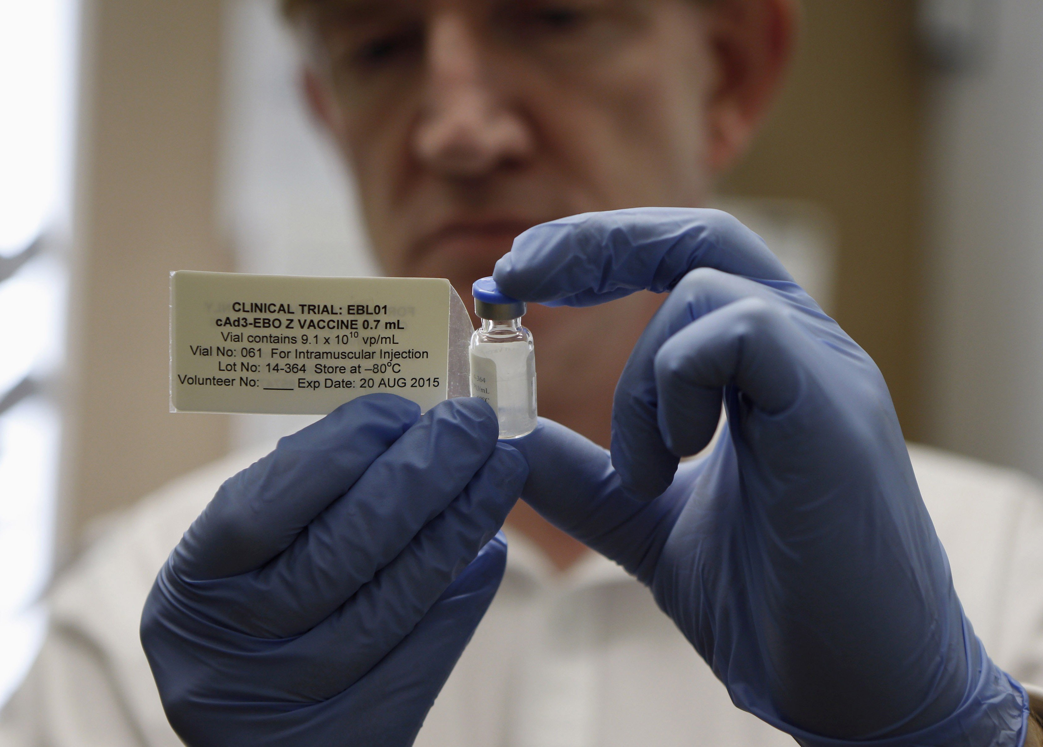 Professor Adrian Hill, Director of the Jenner Institute, and Chief Investigator of the trials, holds a phial containing the Ebola vaccine at the Oxford Vaccine Group Centre for Clinical Vaccinology and Tropical Medicine (CCVTM) in Oxford, southern Englan