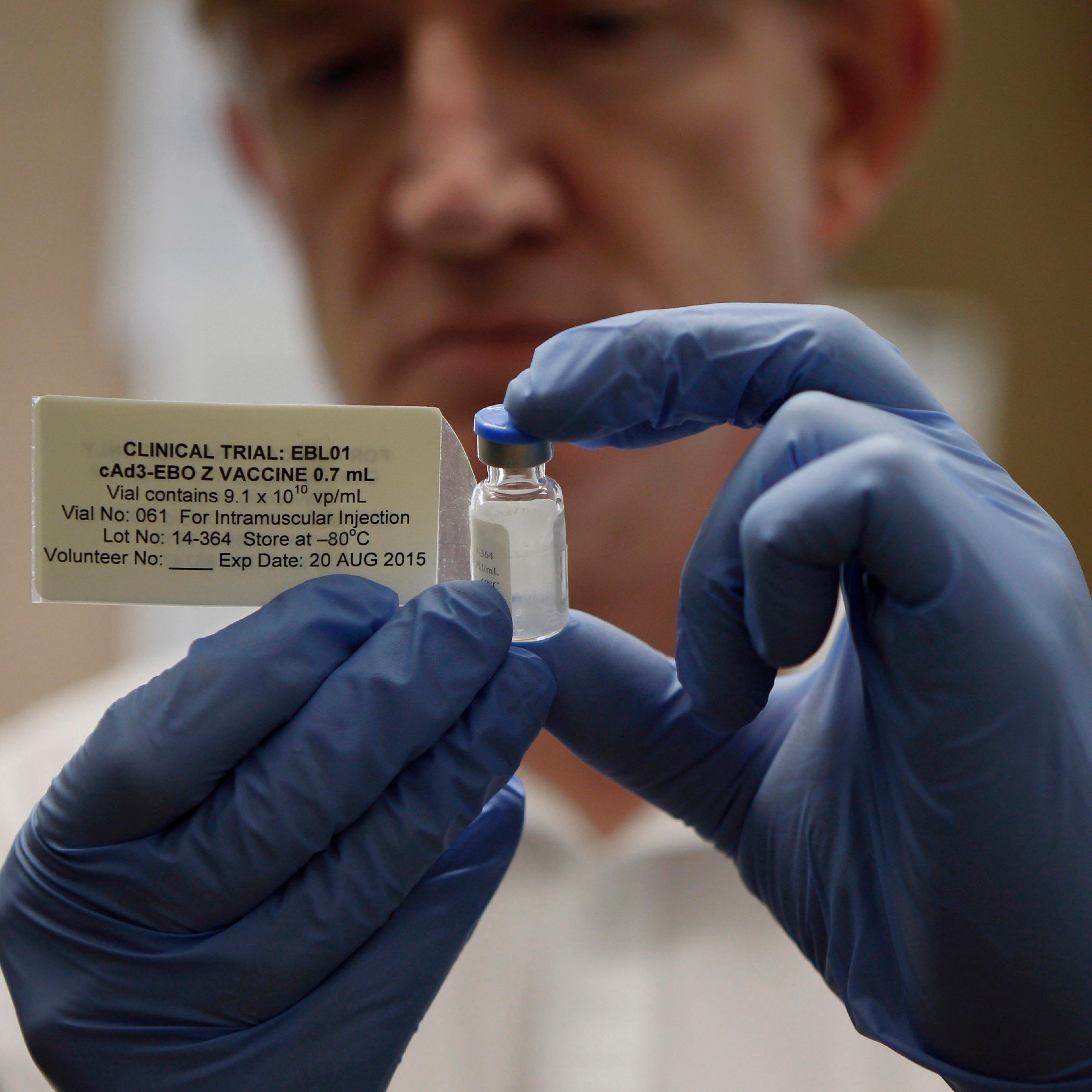 Professor Adrian Hill, Director of the Jenner Institute, and Chief Investigator of the trials, holds a phial containing the Ebola vaccine at the Oxford Vaccine Group Centre for Clinical Vaccinology and Tropical Medicine (CCVTM) in Oxford, southern Englan