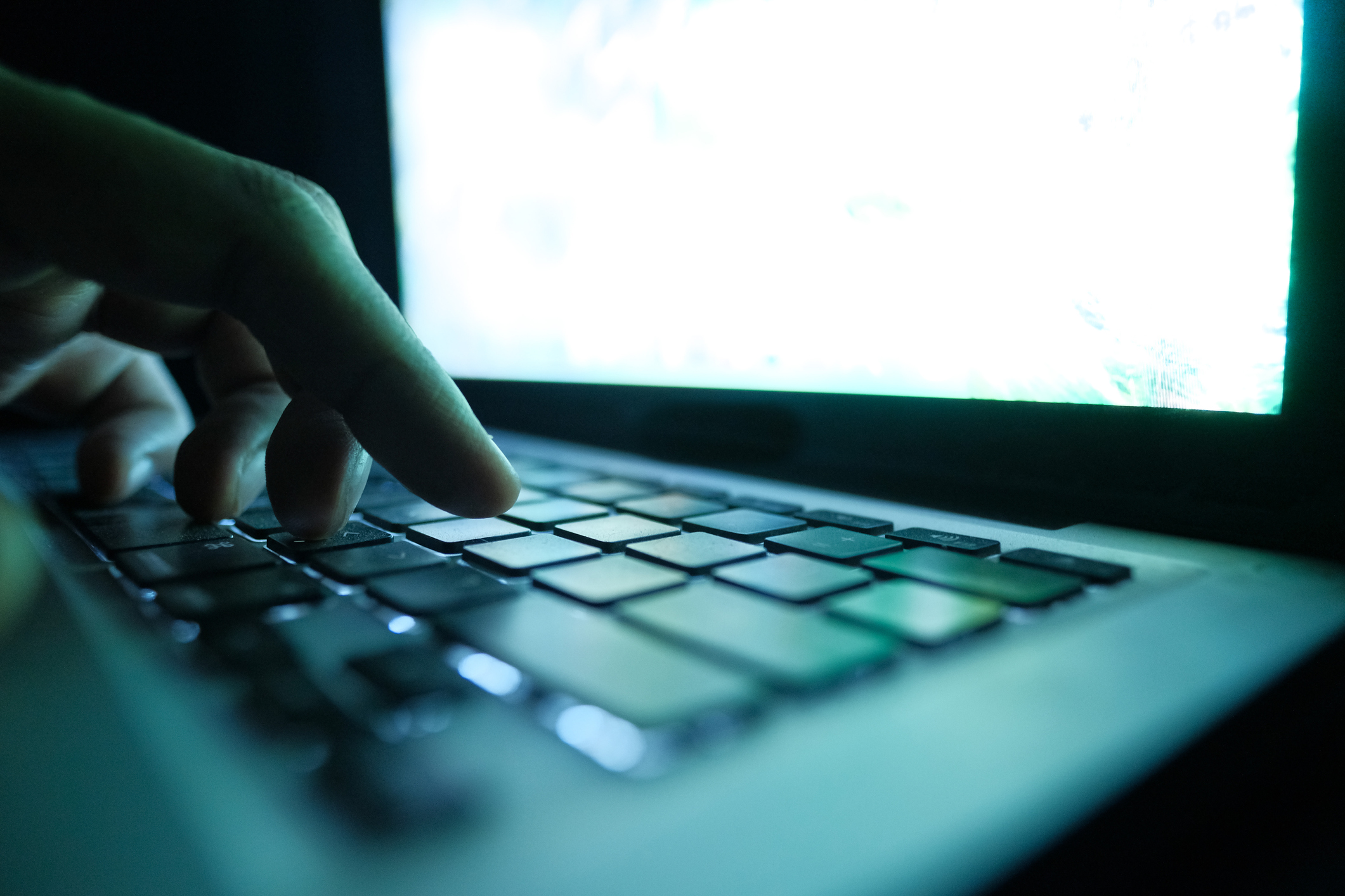 close up of hacker hand typing code