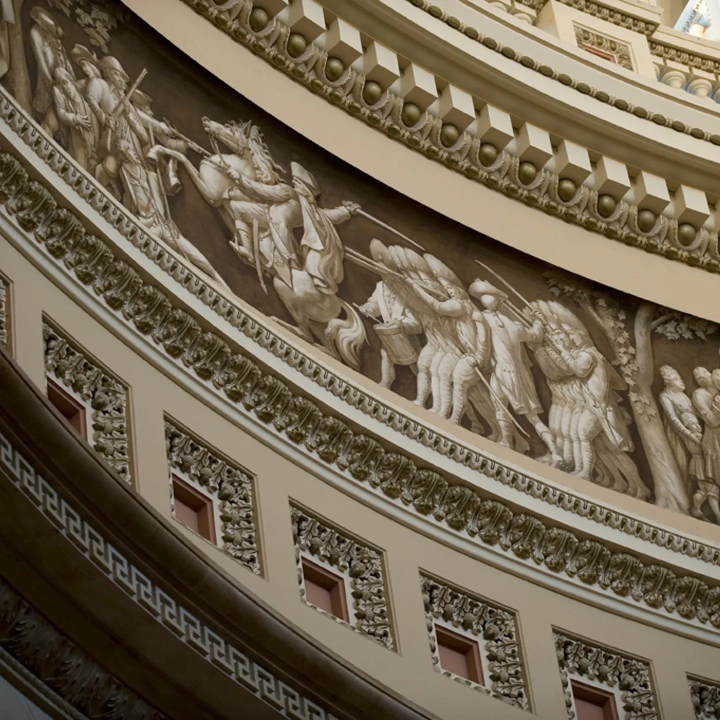 The Frieze of American History in the Rotunda of the United States Capitol, seen ca. 2011, contains a painted panorama depicting significant events in American history. The frieze's 19 scenes is the work of three artists: Constantino Brumidi, Filippo Constaggini and Allyn Cox.