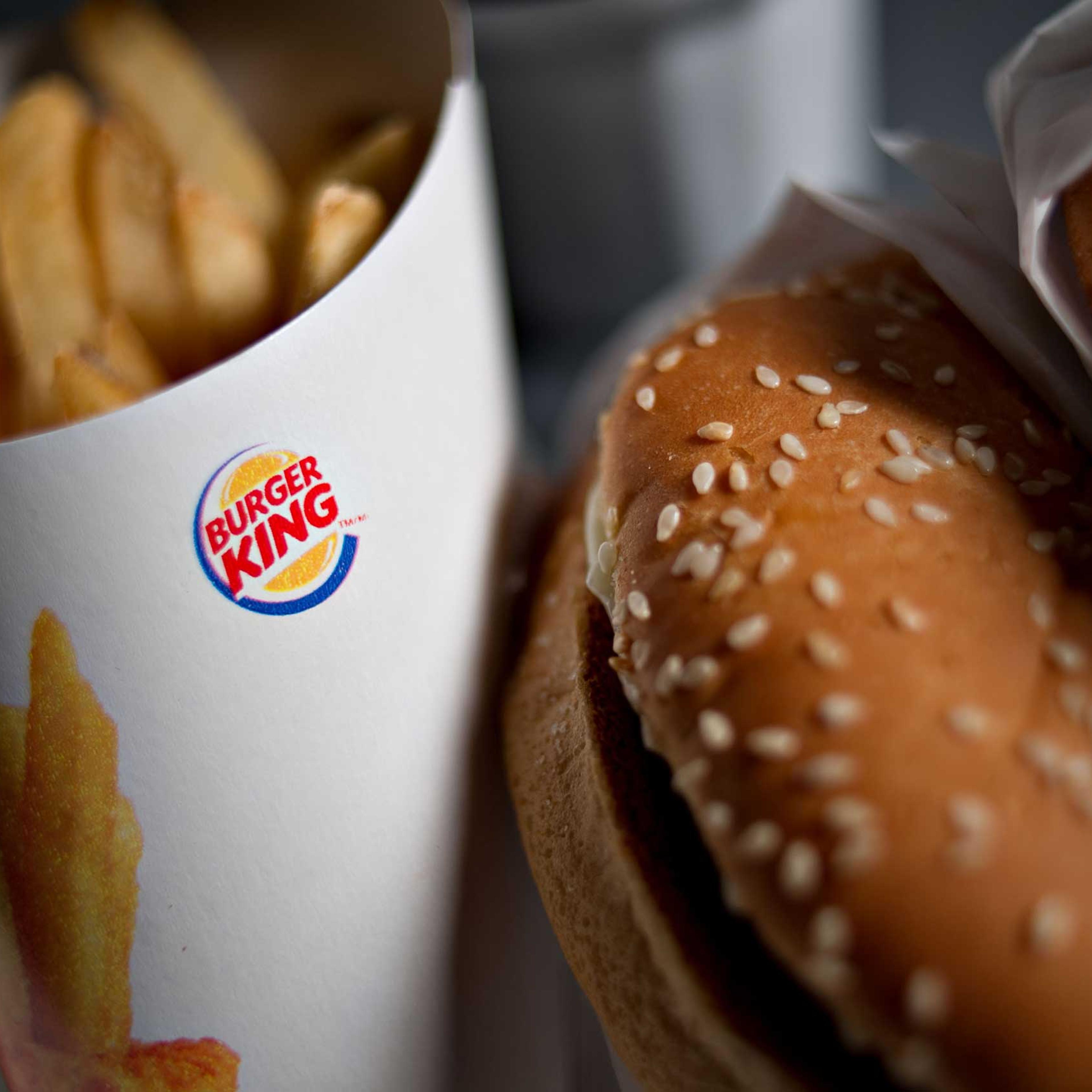 A Burger King Whopper hamburger is arranged with french fries for a photograph in Tiskilwa, Illinois, U.S., on Wednesday, Feb. 13, 2013.