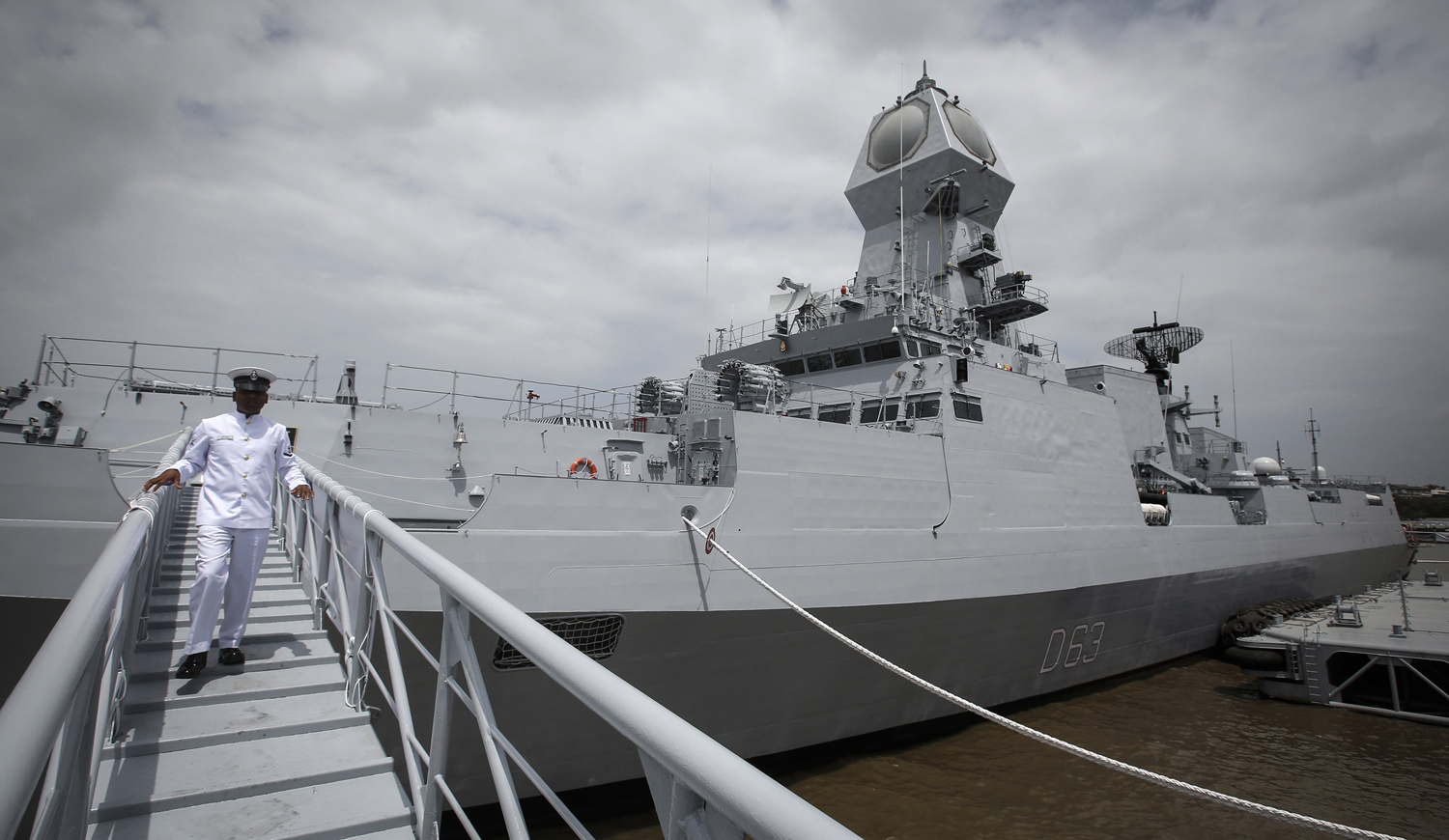 An Indian navy serviceman walks down the gangplank of the newly commissioned warship, INS Kolkata, during its commissioning ceremony at a naval base in Mumbai