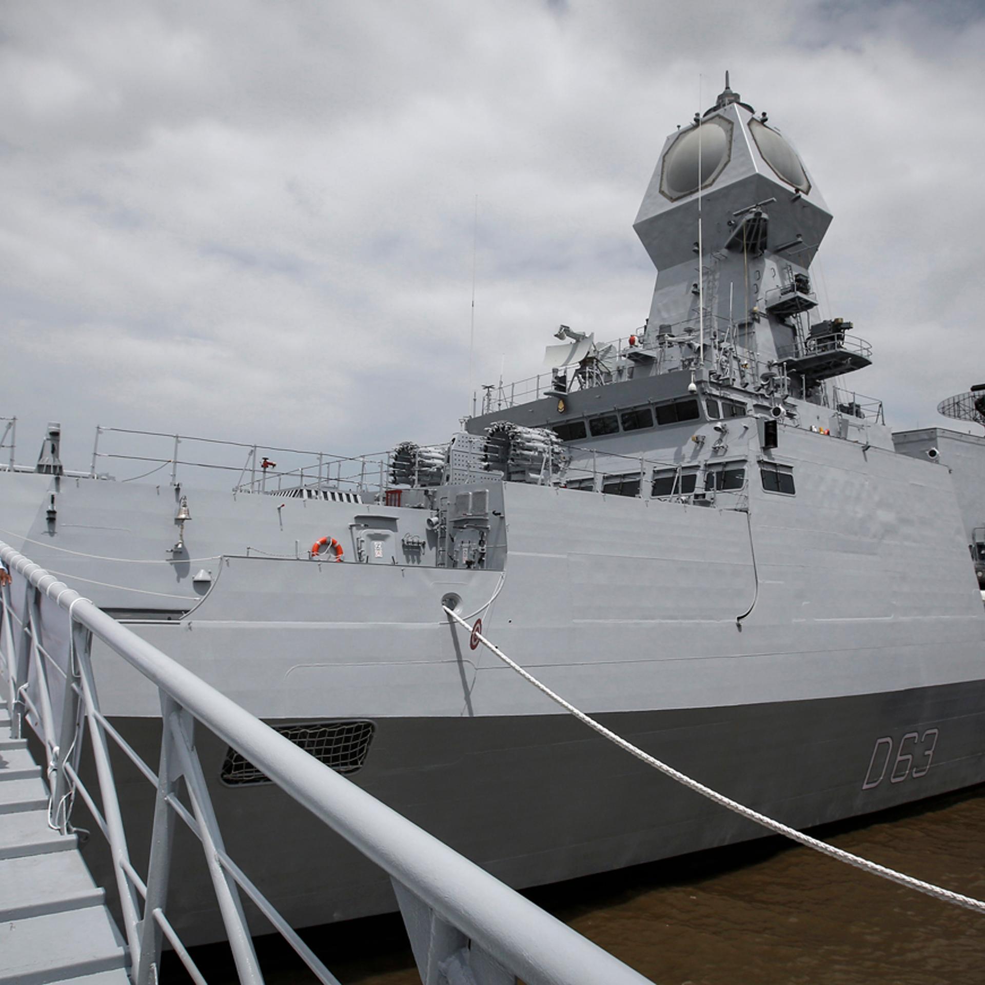 An Indian navy serviceman walks down the gangplank of the newly commissioned warship, INS Kolkata, during its commissioning ceremony at a naval base in Mumbai