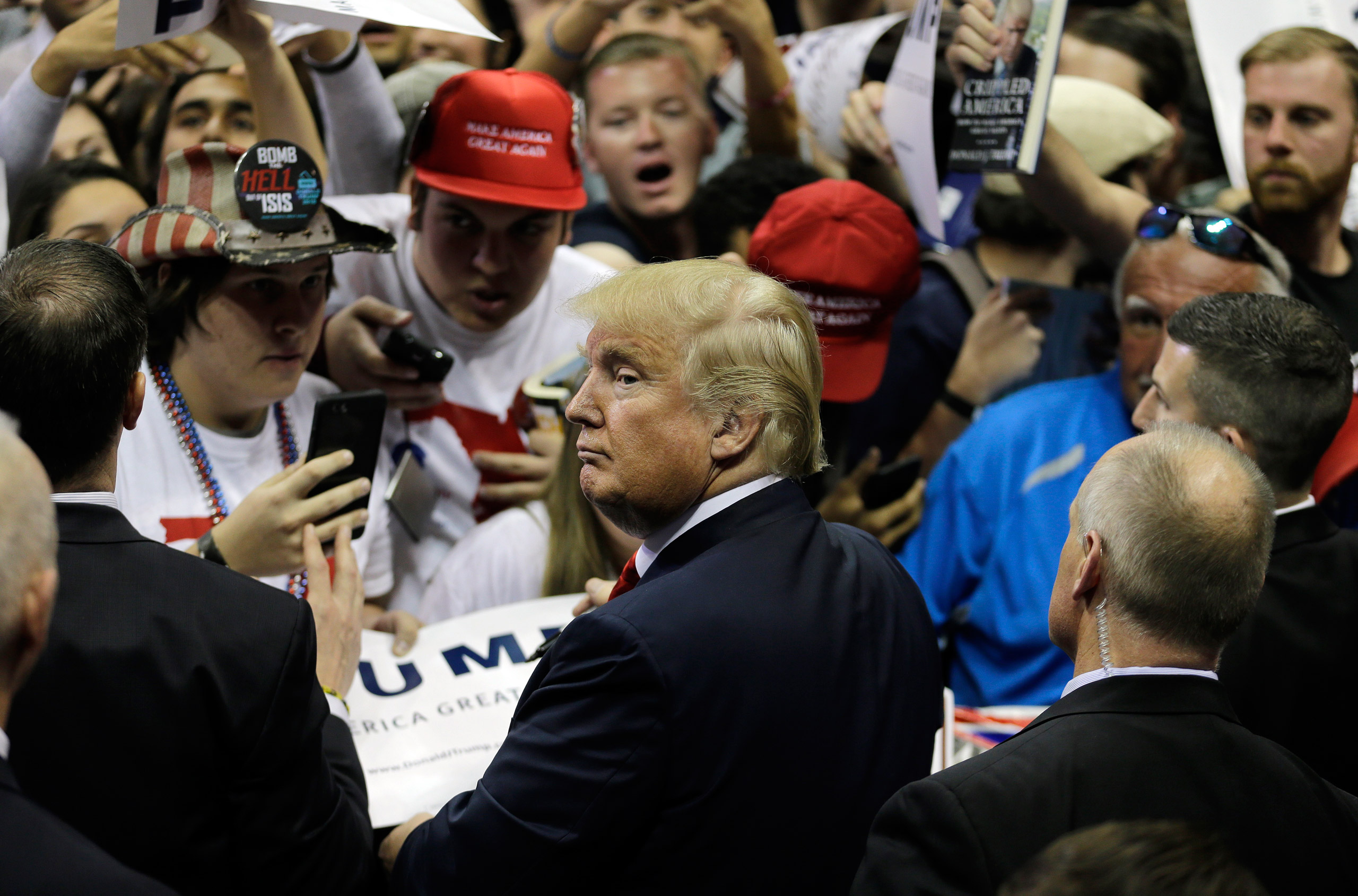 Republican presidential candidate Donald Trump signs autographs during a rally Friday, Feb. 12, 2016, in Tampa, Fla. (AP Photo/Chris O'Meara)