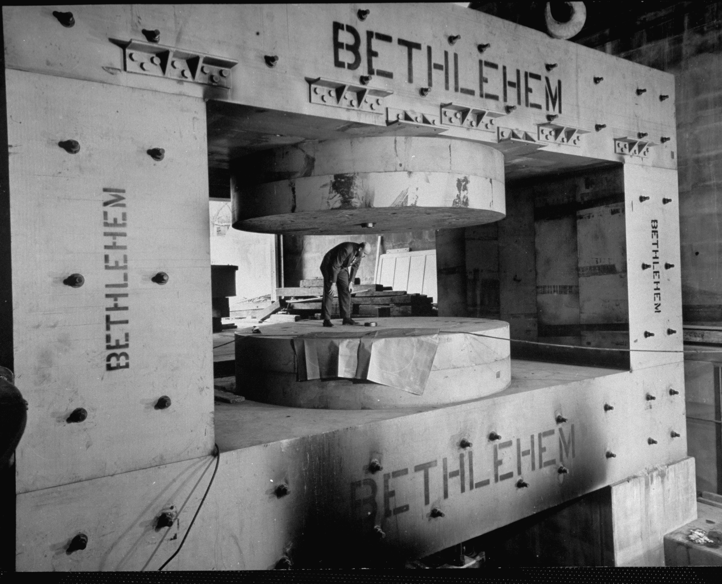 A man inspects a cyclotron's magnet frame under construction at Columbia University's Nevis Lab, Irvington, New York, 1947.