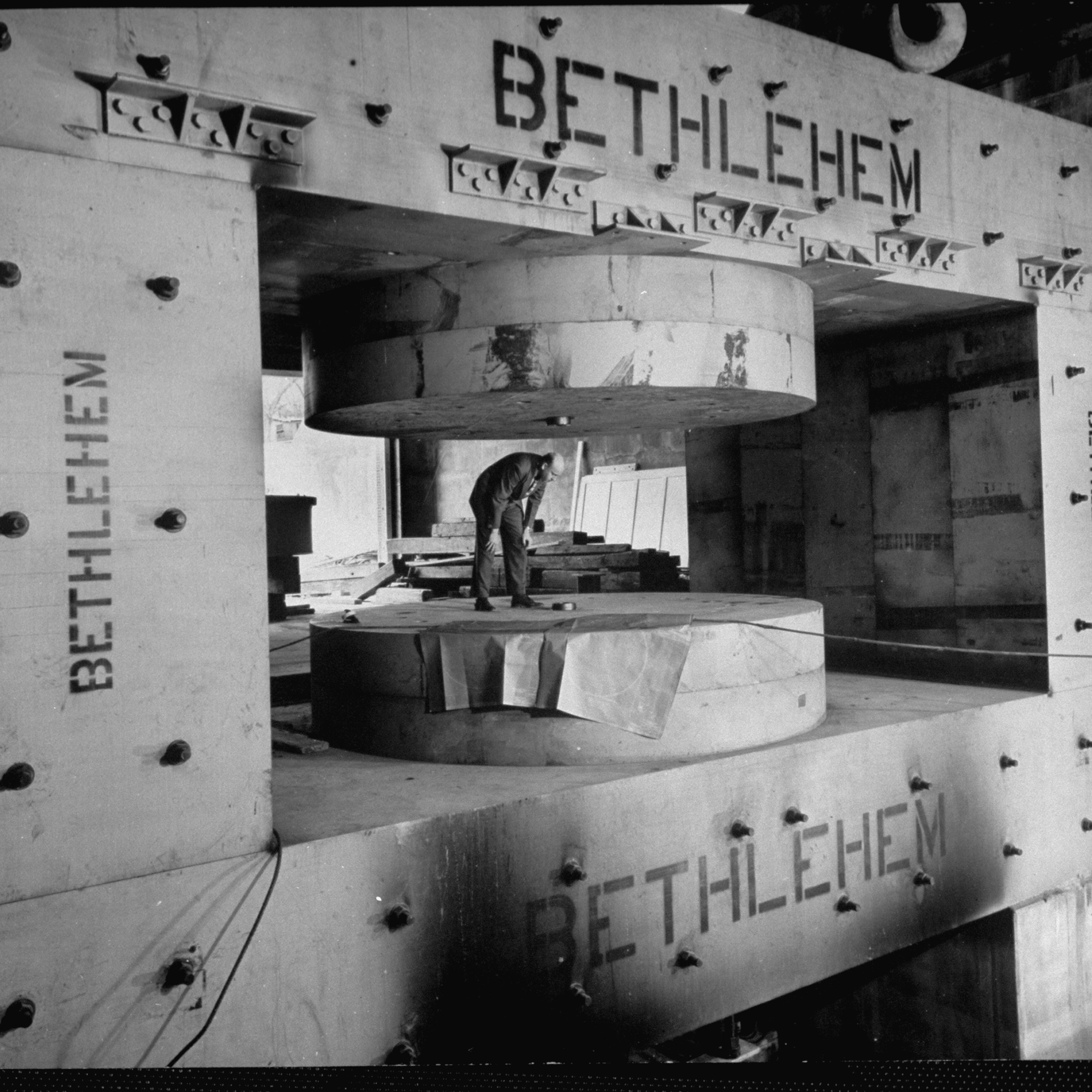 A man inspects a cyclotron's magnet frame under construction at Columbia University's Nevis Lab, Irvington, New York, 1947.