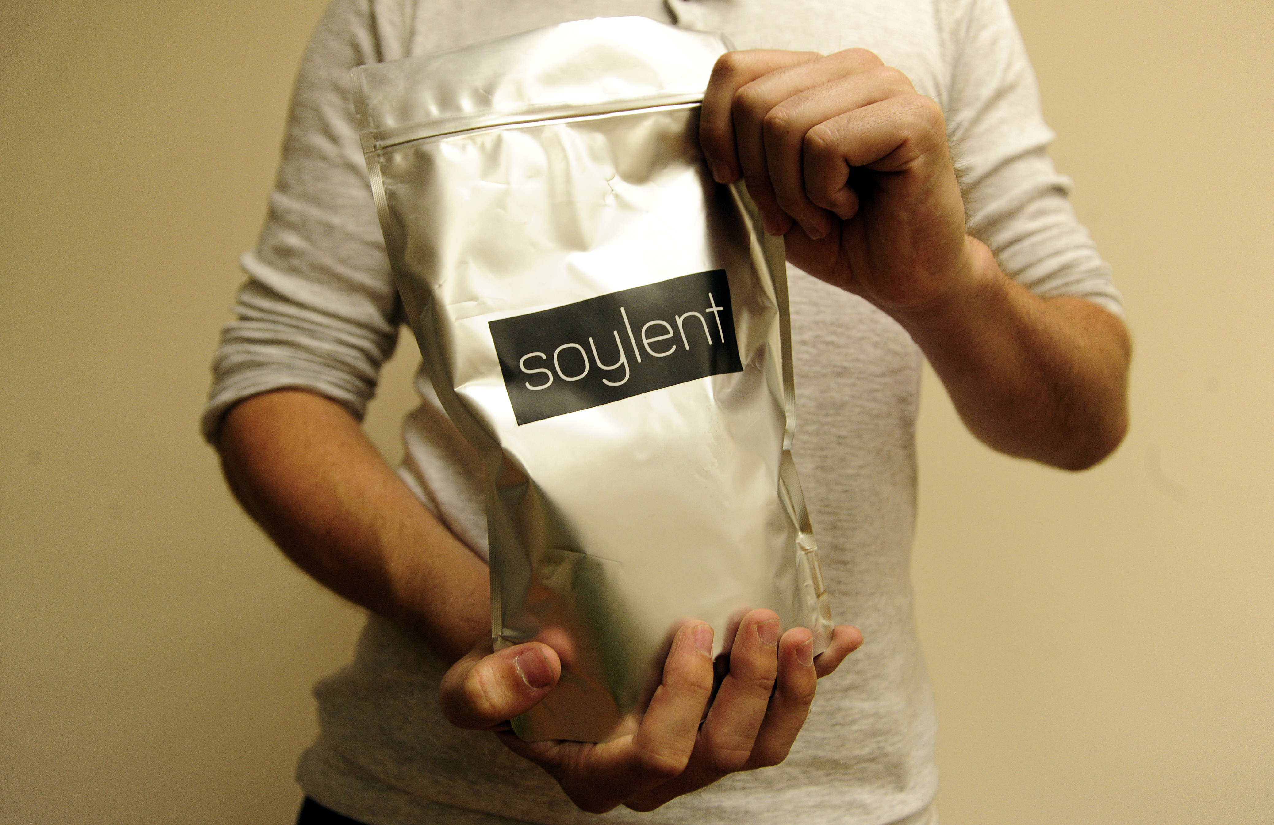 Soylent CEO Rob Rhinehart holds a bag of finished product inside a warehouse in Oakland, California where the company runs its business on September 09, 2013.
