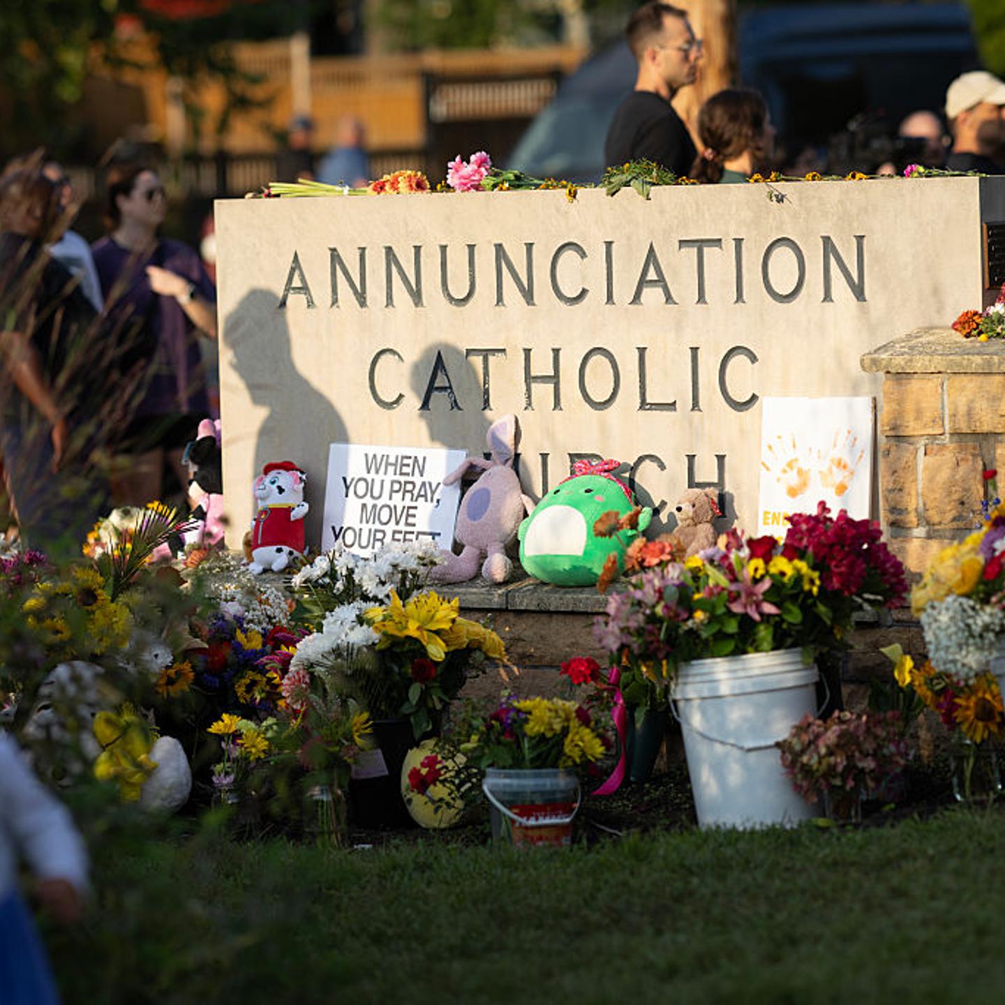 People leave flowers and other mementoes in front of Annunciation Catholic Church, a rapidly growing memorial to the victims of yesterday's shooting in Minneapolis, Minn. on Aug. 28, 2025.