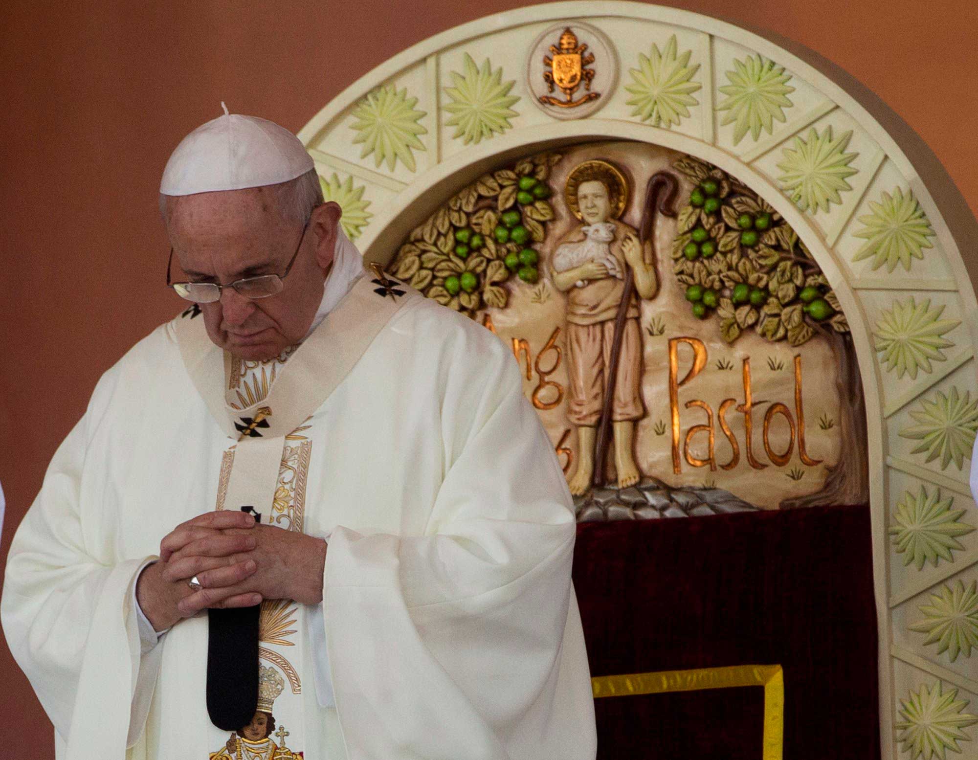 Pope Francis prays during a Mass at Rizal Park in Manila, Jan. 18, 2015.