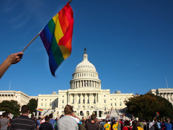 A demonstrator waves a rainbow flag in front of the US Capitol in Washington on October 11, 2009 as tens of thousands of gay activists marched to demand civil rights, a day after President Barack Obama vowed to repeal a ban on gays serving openly in the 