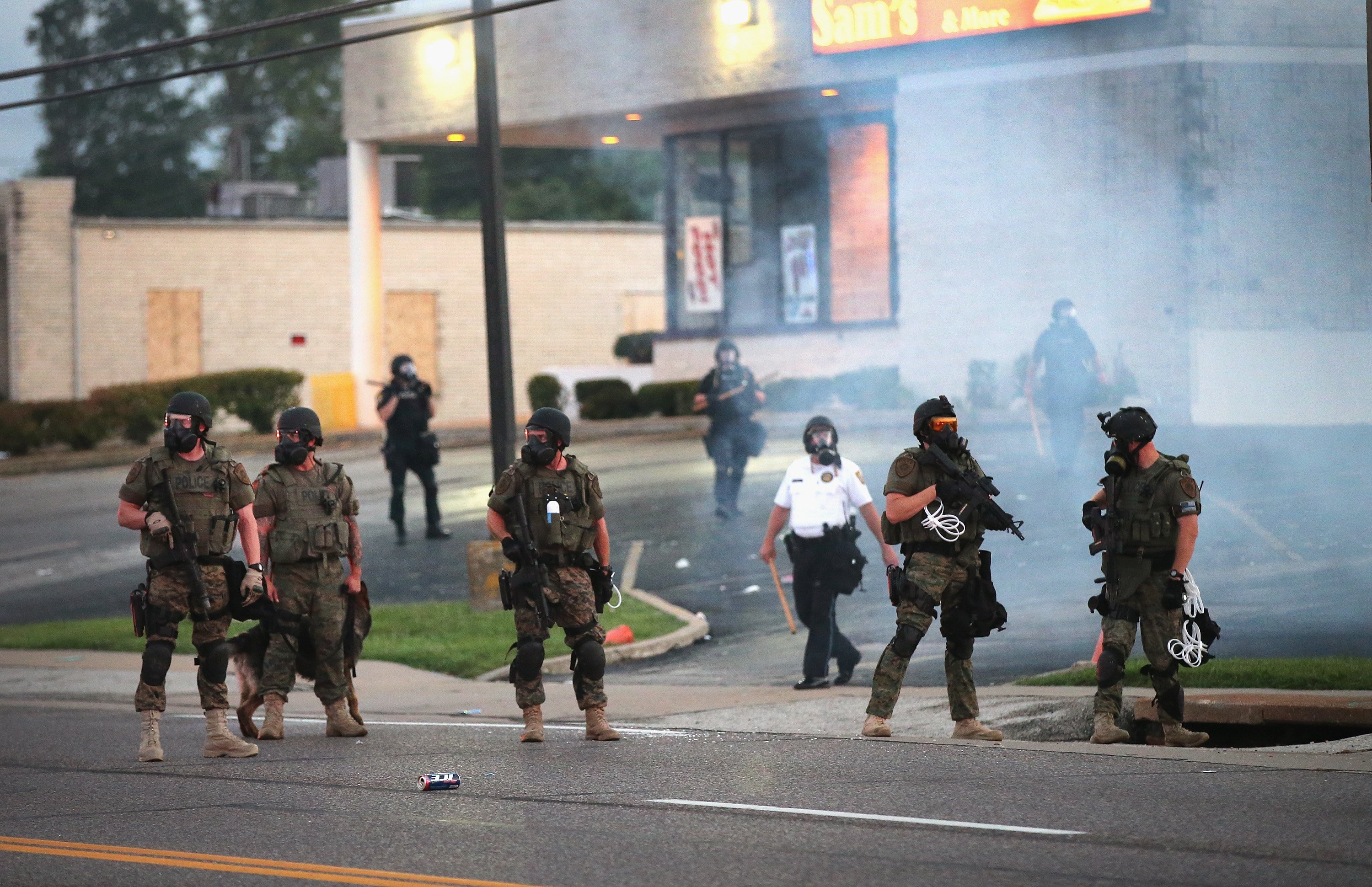 Tear gas hangs in the air as police force protestors from the business district into nearby neighborhoods on August 11, 2014 in Ferguson, Missouri.