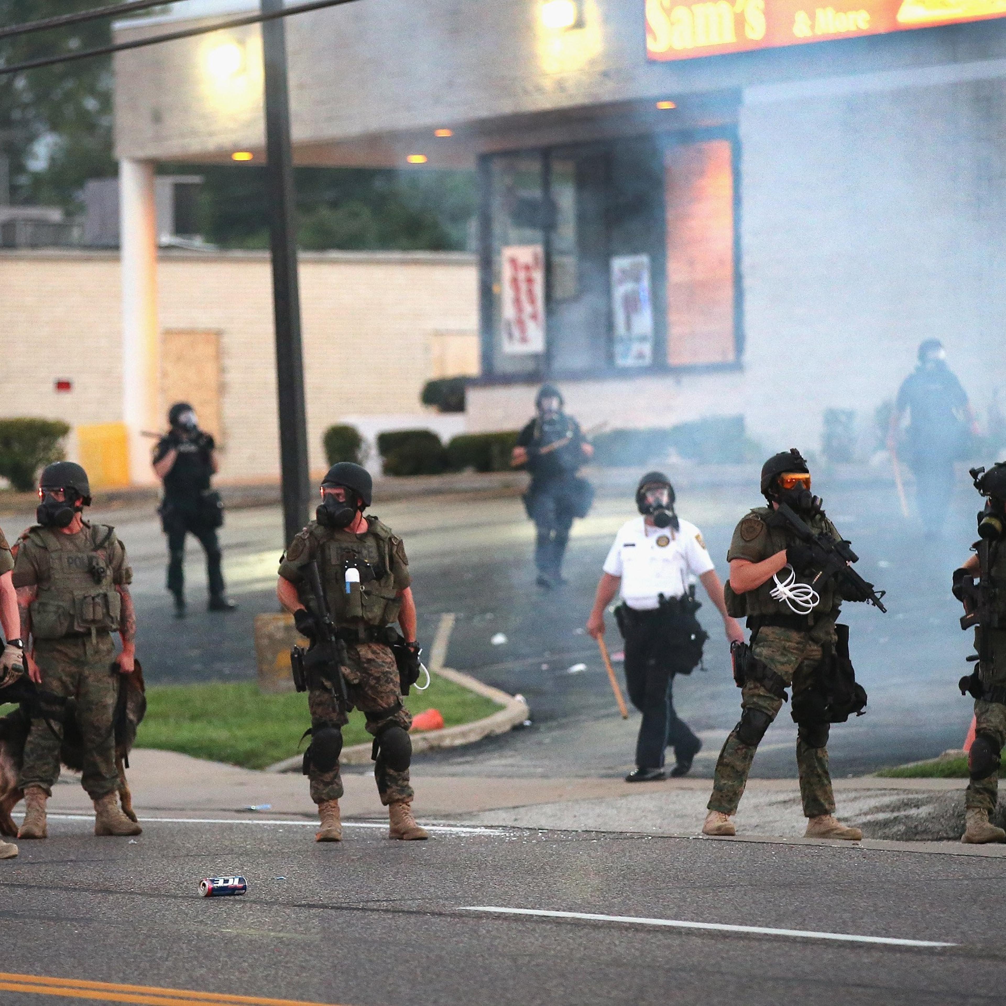 Tear gas hangs in the air as police force protestors from the business district into nearby neighborhoods on August 11, 2014 in Ferguson, Missouri.