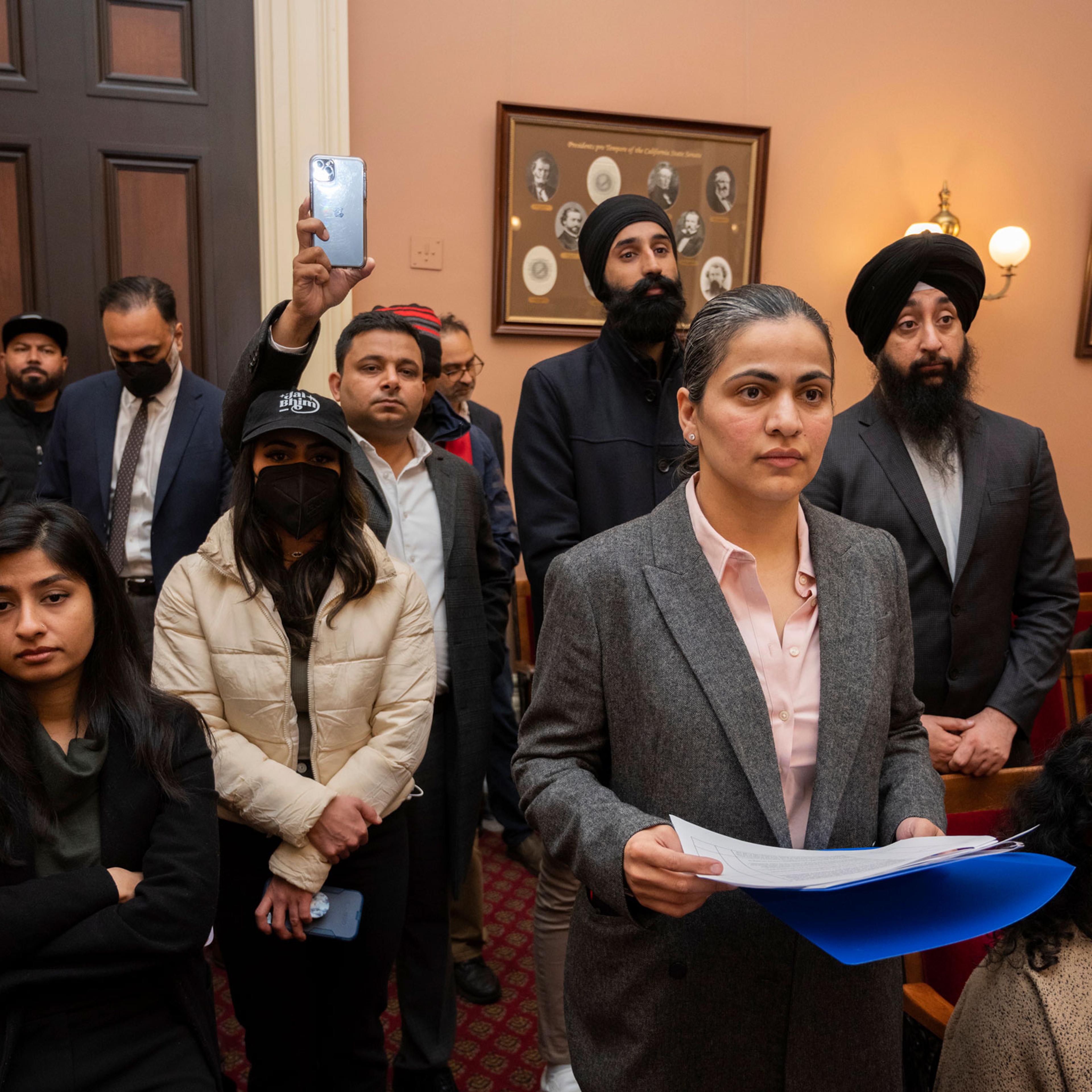 Califiornia state Sen. Aisha Wahab, foreground, listens to speakers during a news conference