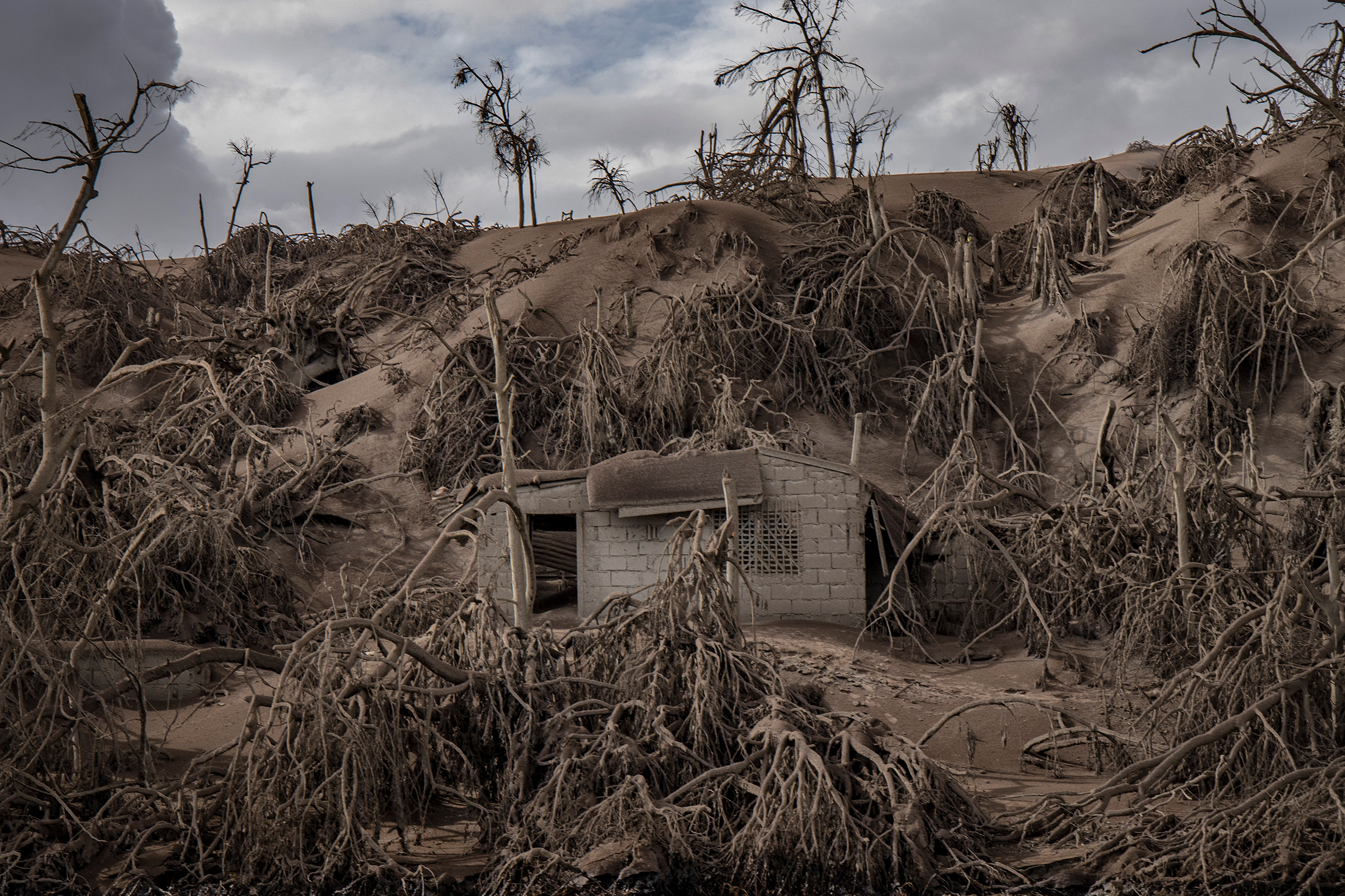 A house near the Taal volcano's crater is buried in ash on Jan. 14.