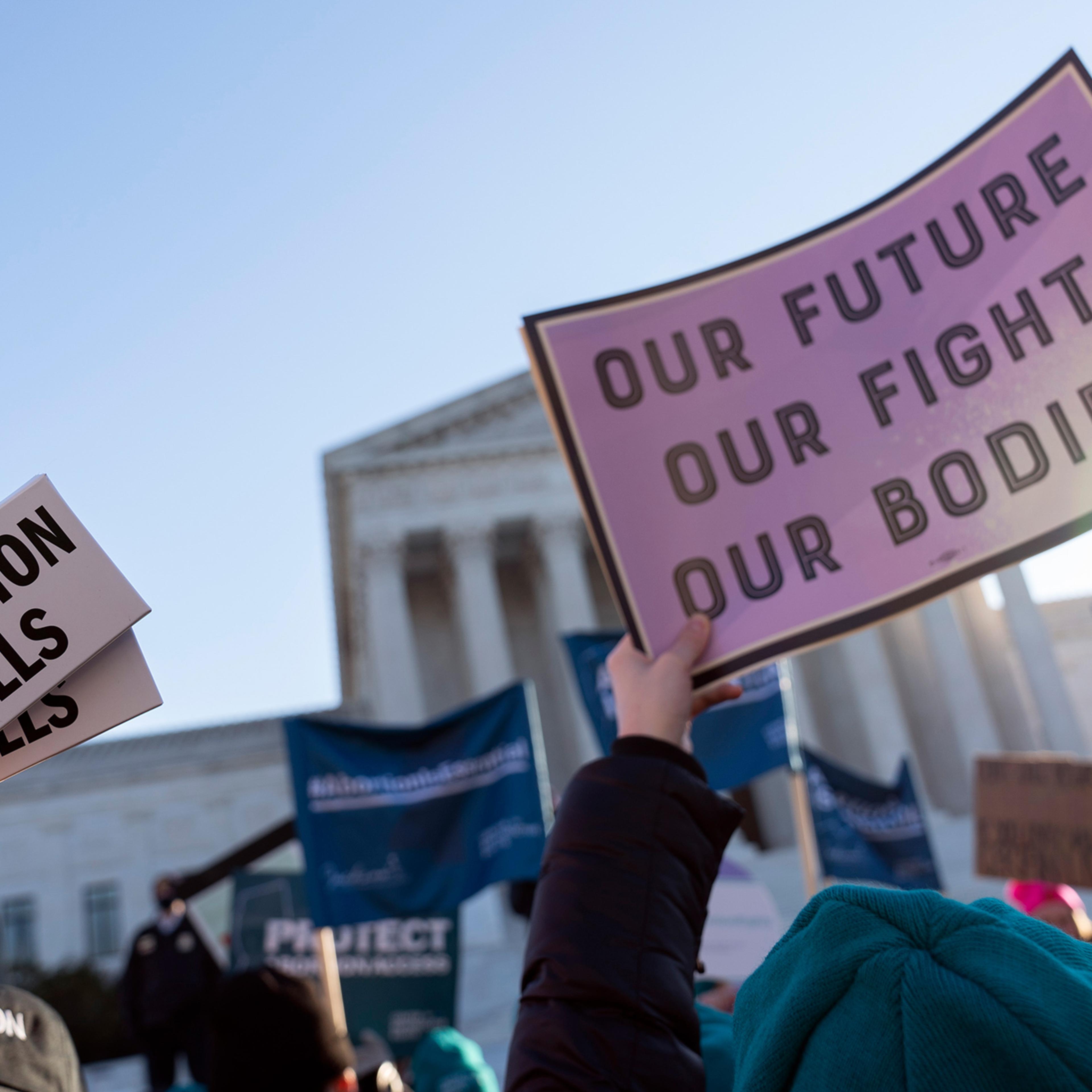 Abortion rights advocates showing a pack of abortion pills demonstrate in front of the U.S. Supreme Court Wednesday, Dec. 1, 2021, in Washington, DC.