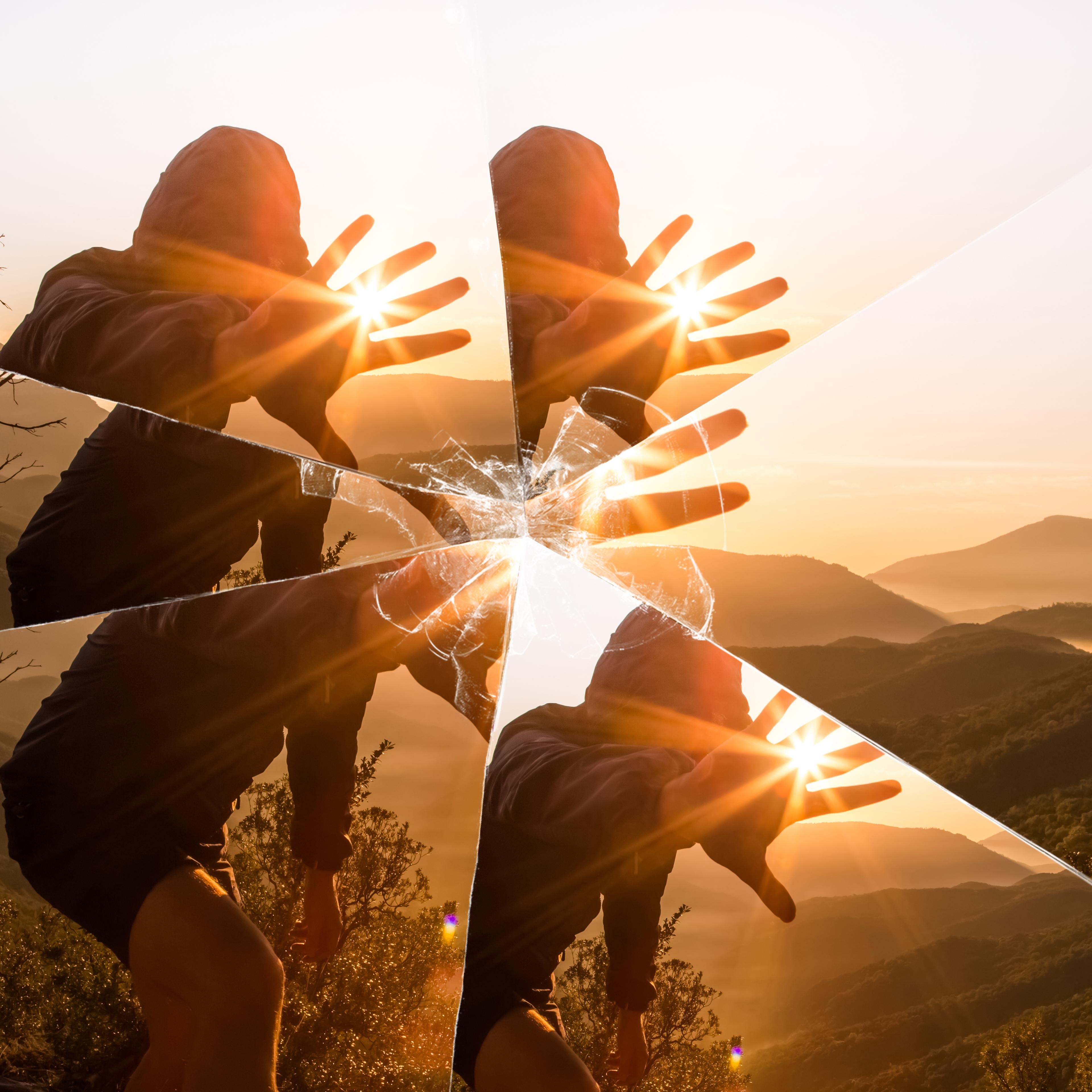 INJY-Mirror-Mystic picture of guy playing with sunlight during sunrise in the nature seen through a broken mirror.