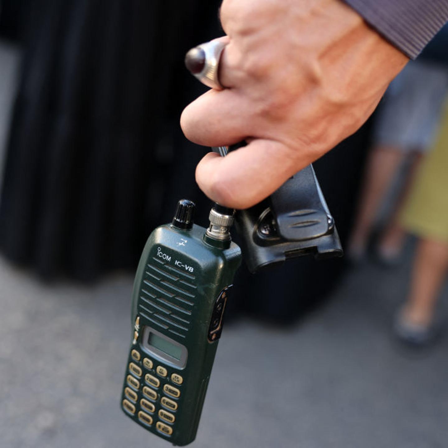 A man holds a walkie-talkie during the funeral of people killed in the explosions of pagers across Lebanon, in Beirut's southern suburbs, on Sept. 18, 2024.