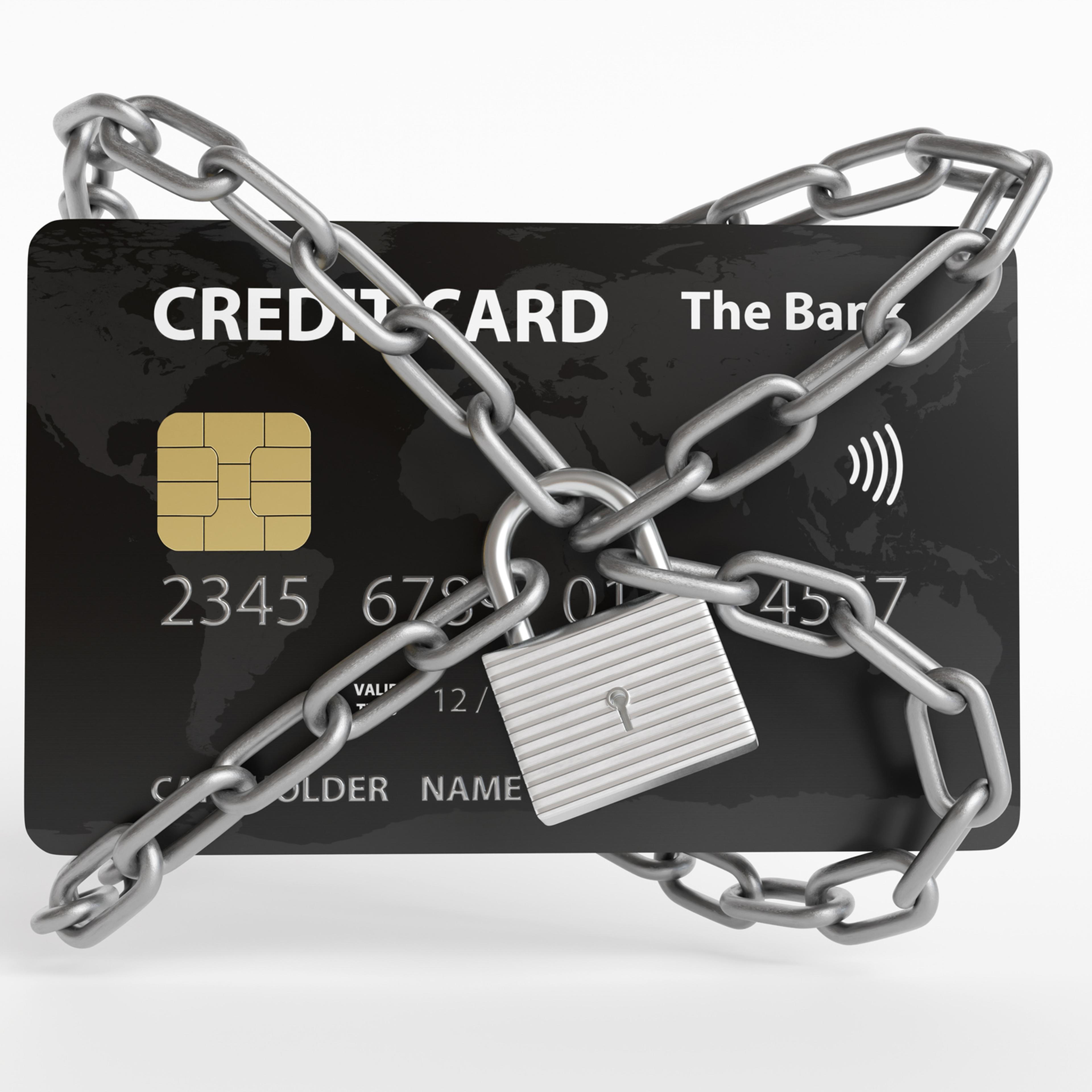 Black credit card being locked by silver metallic chains and a padlock on white background. Illustration of the concept of security of contactless payments, digital wallets, online transactions