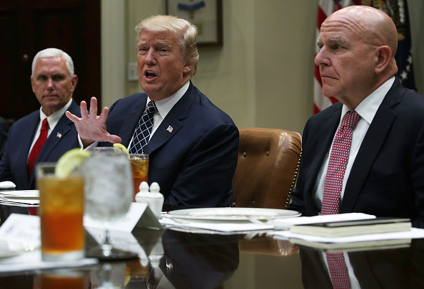 U.S. President Donald Trump (C) speaks to members of the media as Vice President Mike Pence (L) and National Security Adviser H.R. McMaster (R) listen during a lunch with service members at the Roosevelt Room of the White House July 18, 2017 in Washingto