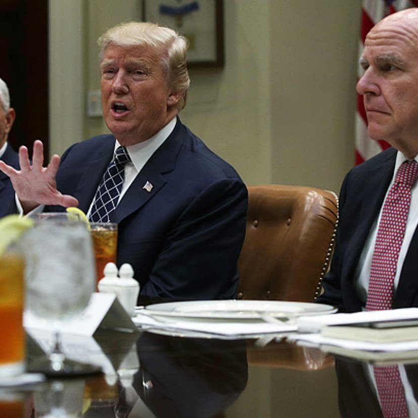 U.S. President Donald Trump (C) speaks to members of the media as Vice President Mike Pence (L) and National Security Adviser H.R. McMaster (R) listen during a lunch with service members at the Roosevelt Room of the White House July 18, 2017 in Washingto