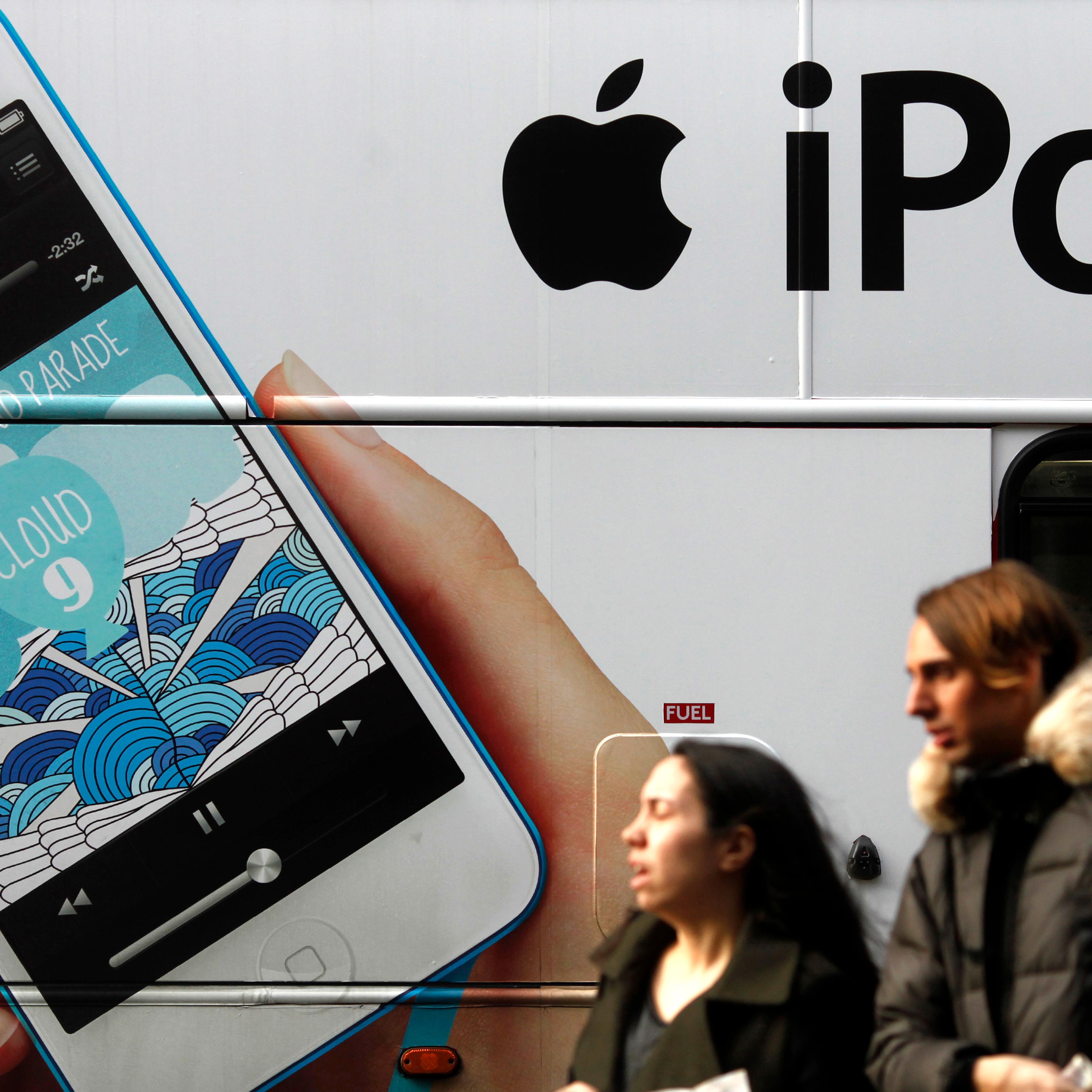 An advertisement for Apple's iPod is displayed on the side of a London bus, Dec. 21, 2012.