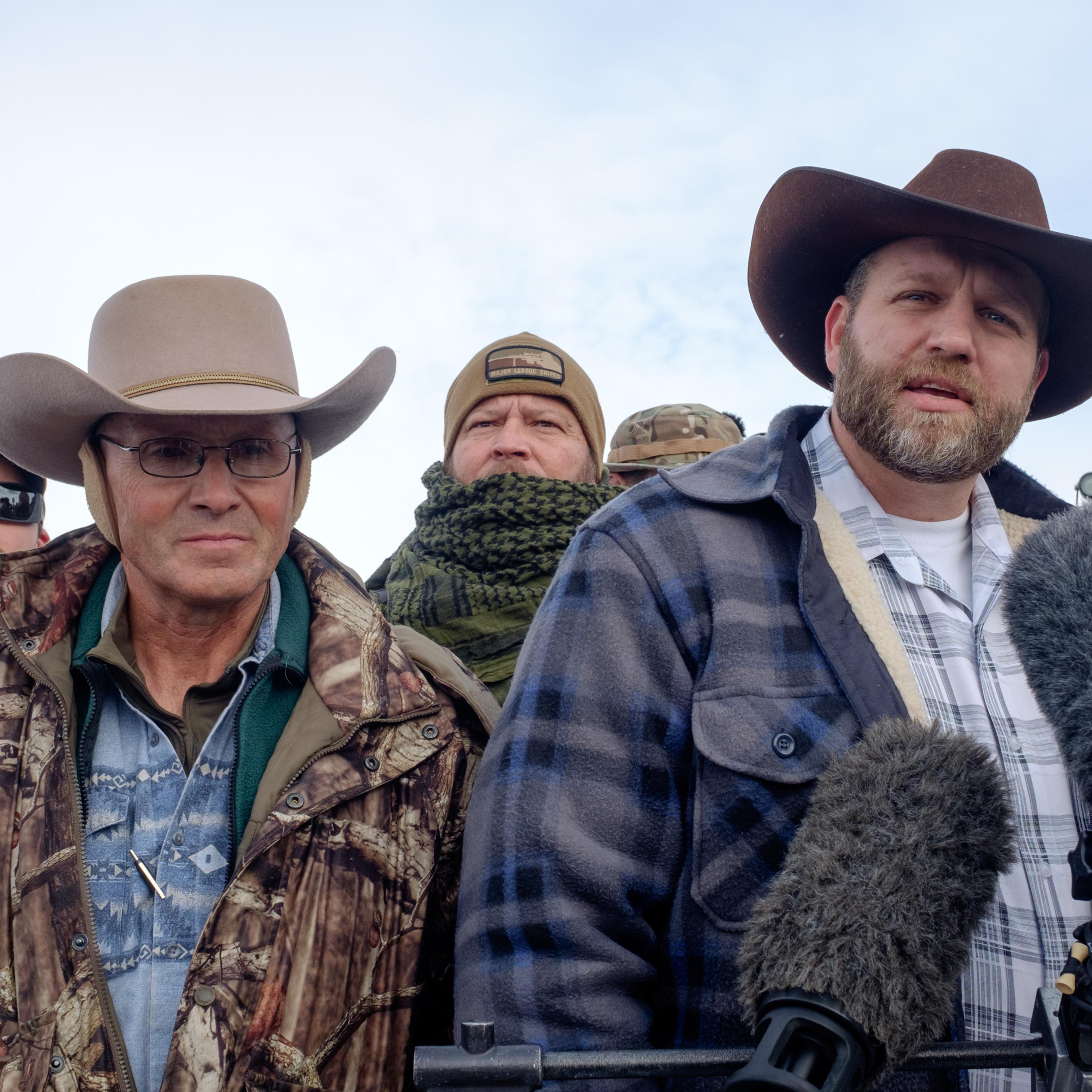 Ammon Bundy(R), leader of a group of armed anti-government protesters speaks to the media as other members look on at the Malheur National Wildlife Refuge near Burns, Ore., on Jan. 4, 2016.