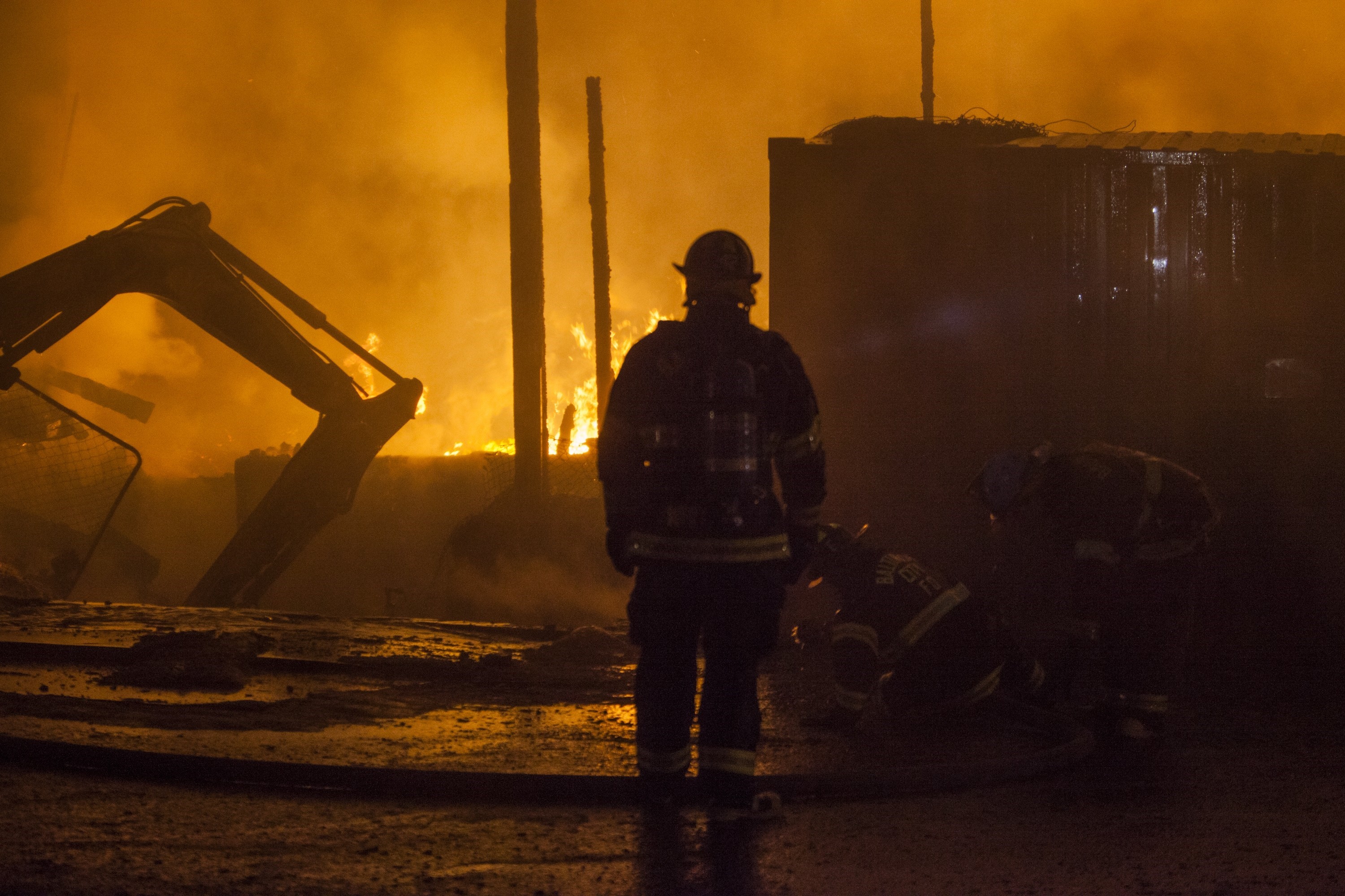 Fire fighter attempts to put out a building that was set on fire during riots in Baltimore, USA on April 27, 2015.
