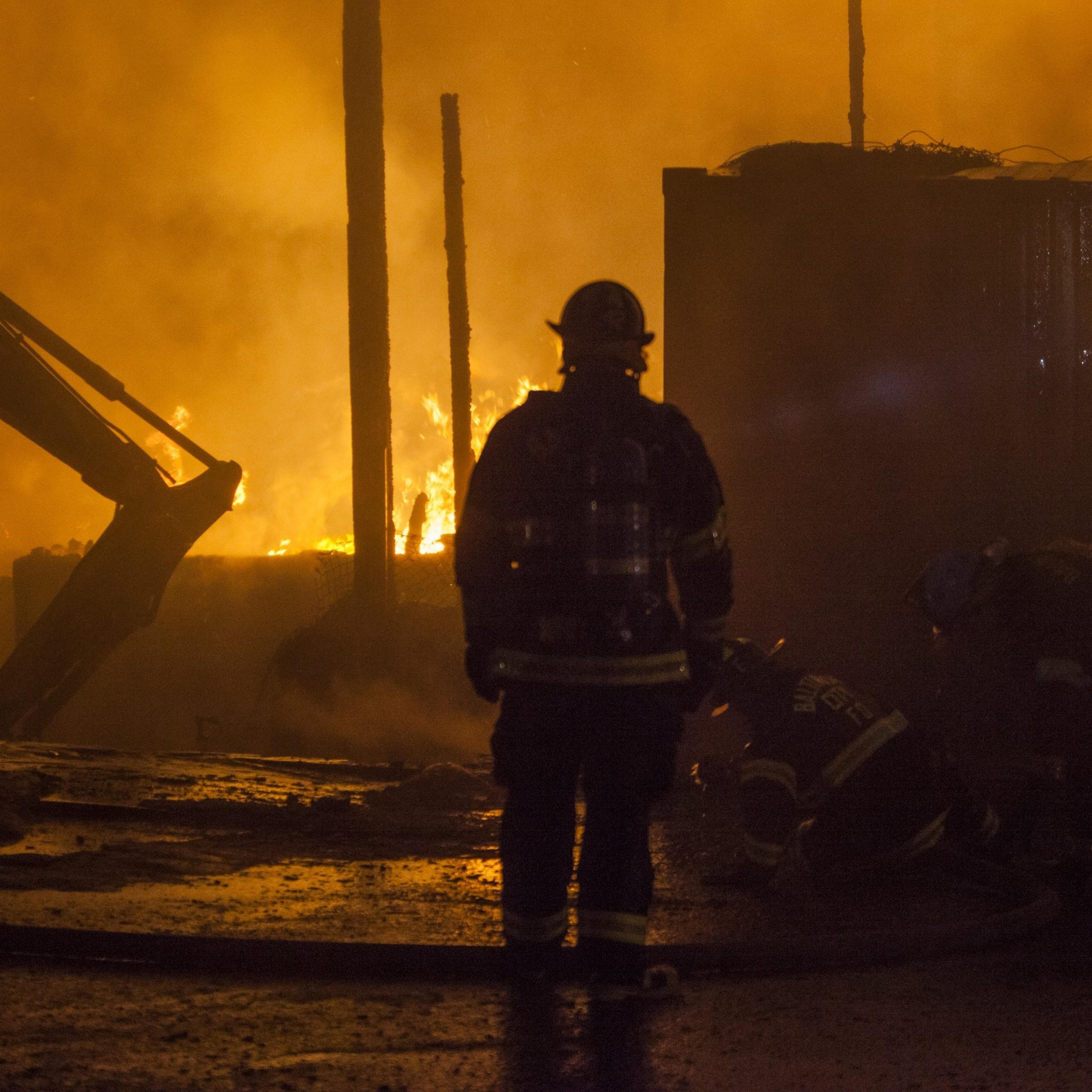 Fire fighter attempts to put out a building that was set on fire during riots in Baltimore, USA on April 27, 2015.