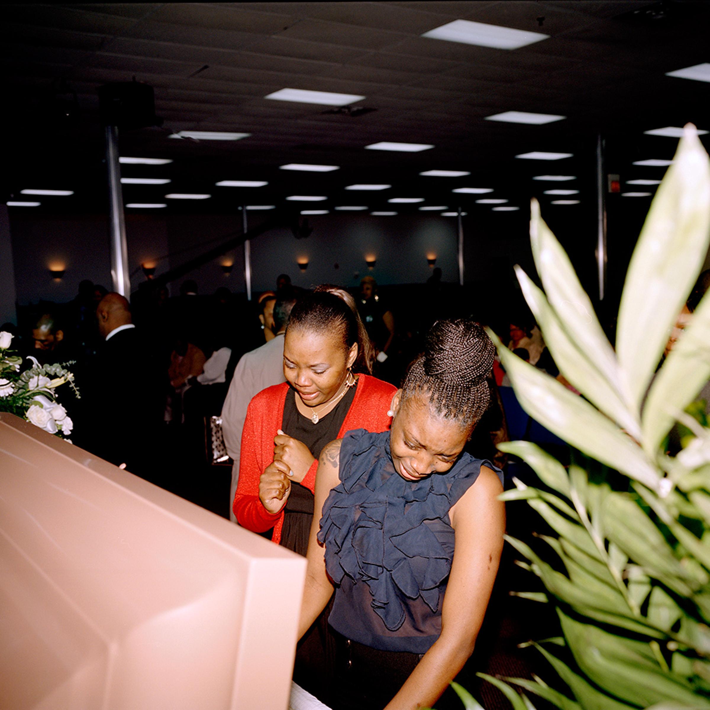 Friends of Deshaun Williams attend his funeral at the Monument of Faith Church in Chicago. Williams was killed in a shooting outside an Englewood nightclub the evening of February 22, 2013 at the age of 25. He was a graduate of the University of Houston, where he played basketball.