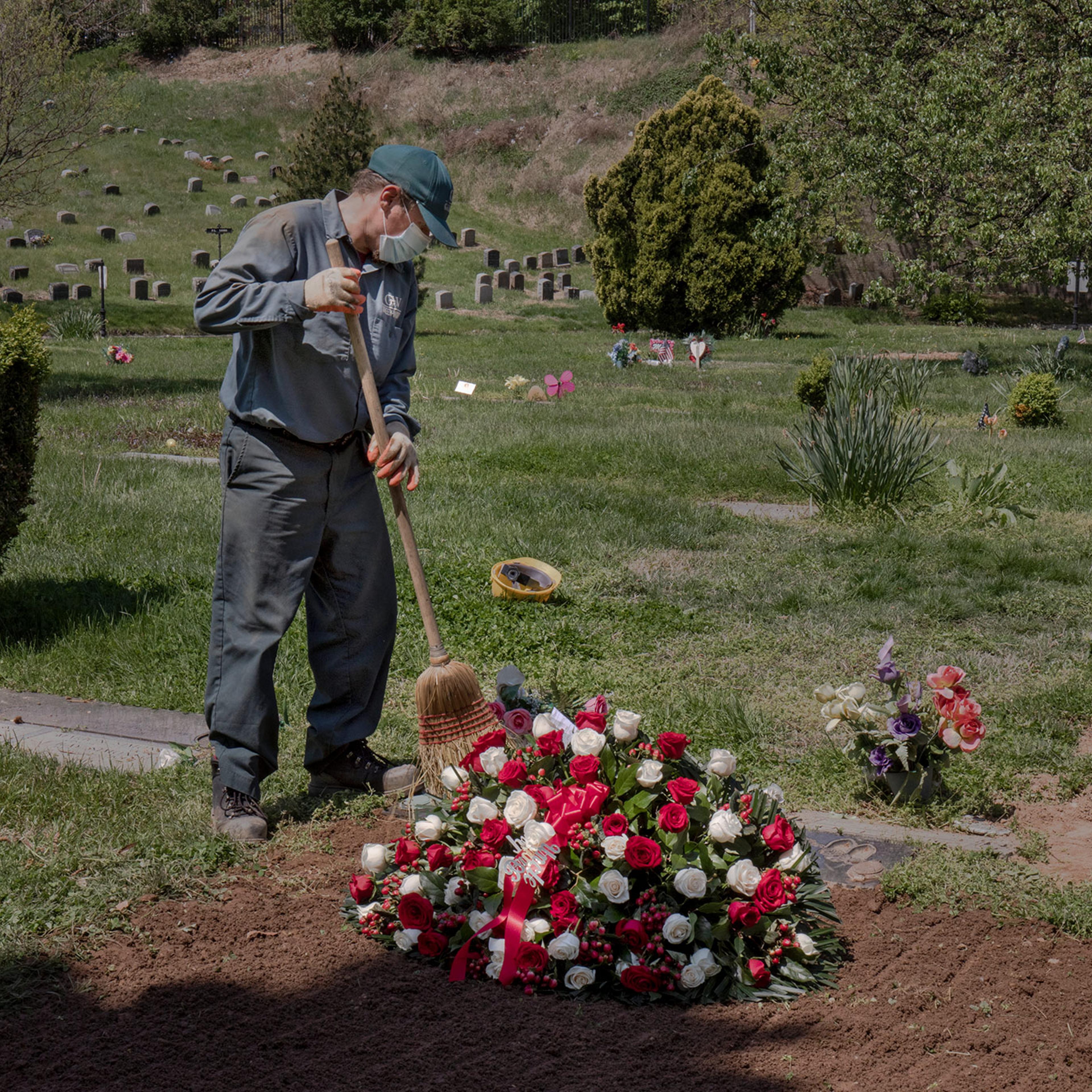 Janusz Karkos tends the grave of a COVID-19 victim at Brooklyn's Green-Wood Cemetary on May 4. As of Sept. 21, the U.S. coronavirus death toll surpassed 200,000
