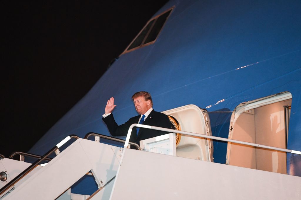 President Donald Trump waves as he disembarks from Air Force One upon his arrival in Vietnam for a second summit with North Korean leader Kim Jong Un