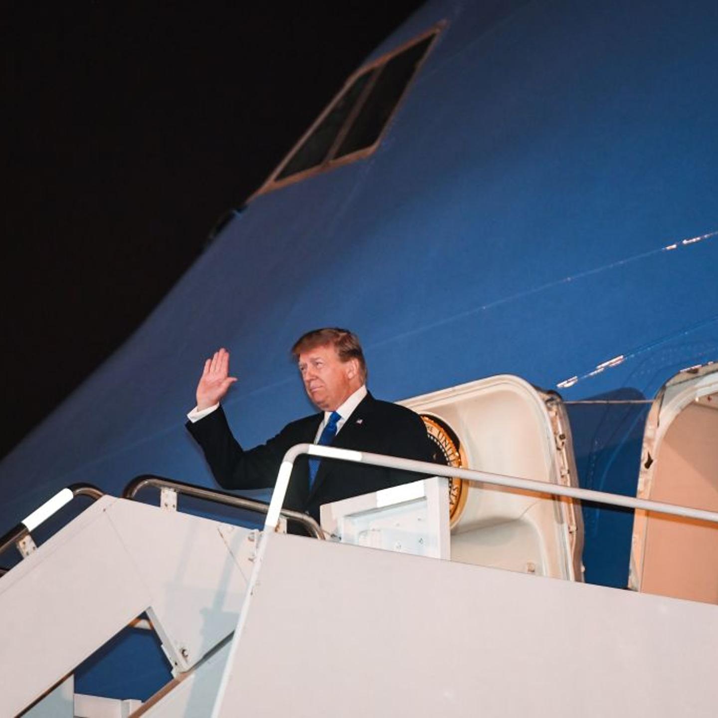 President Donald Trump waves as he disembarks from Air Force One upon his arrival in Vietnam for a second summit with North Korean leader Kim Jong Un