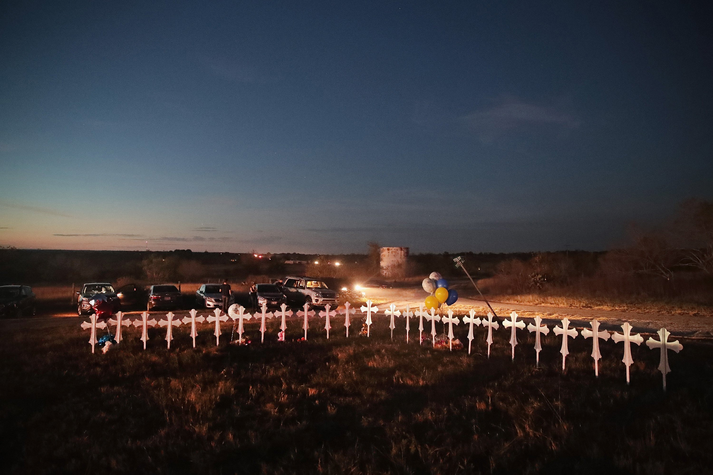 Twenty-six crosses, one for each of the dead, stand in a field on the edge of town on Nov. 6
