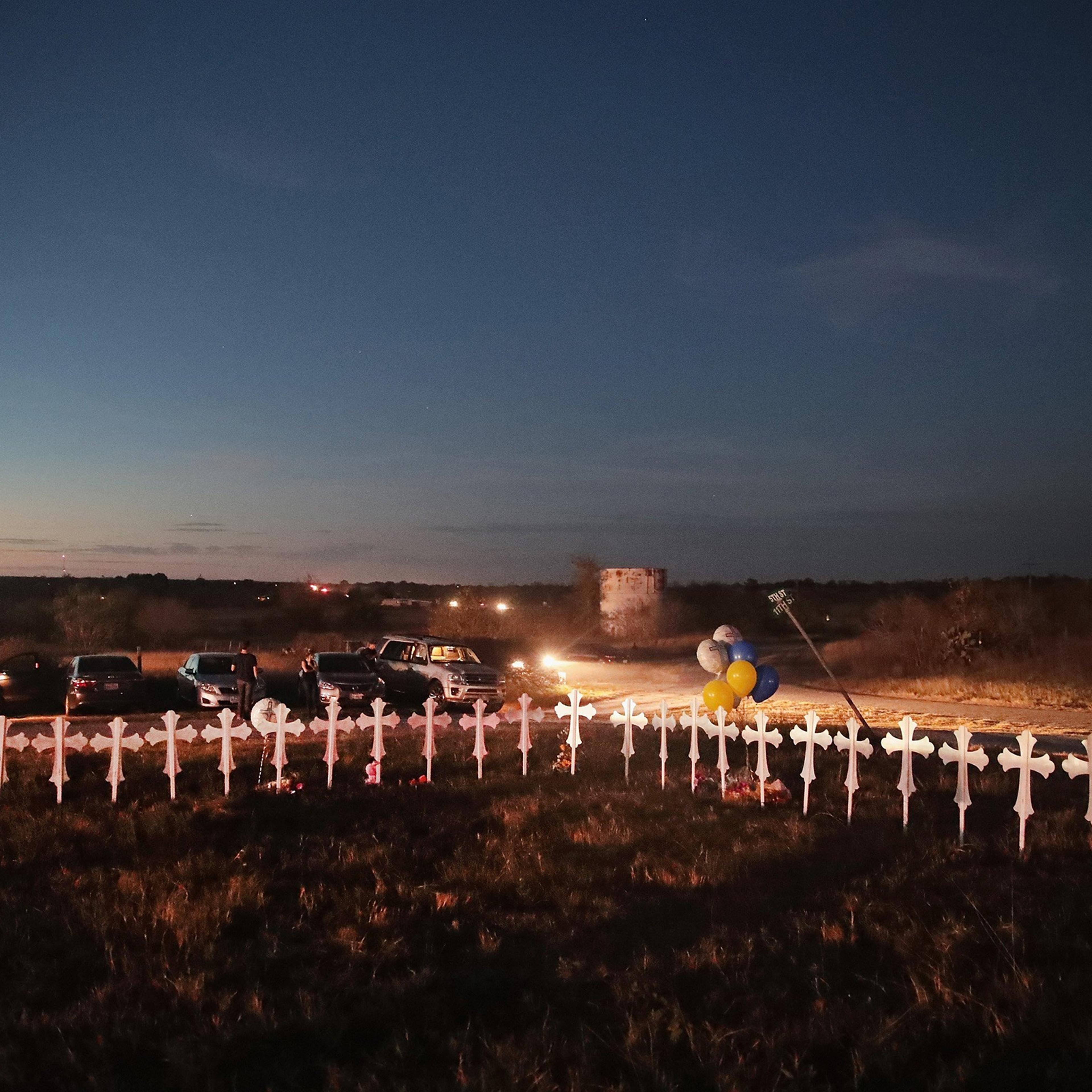 Twenty-six crosses, one for each of the dead, stand in a field on the edge of town on Nov. 6