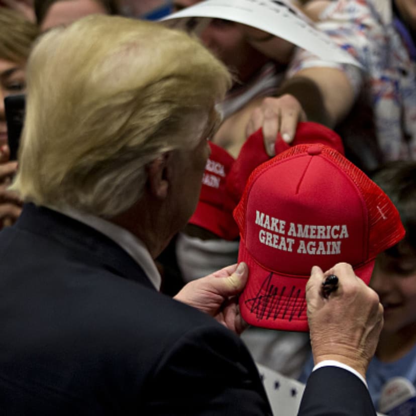 Donald Trump, president and chief executive of Trump Organization Inc. and 2016 Republican presidential candidate, signs a campaign hat after speaking during a campaign rally at West Chester University in West Chester, Pennsylvania, U.S., on Monday, Apri