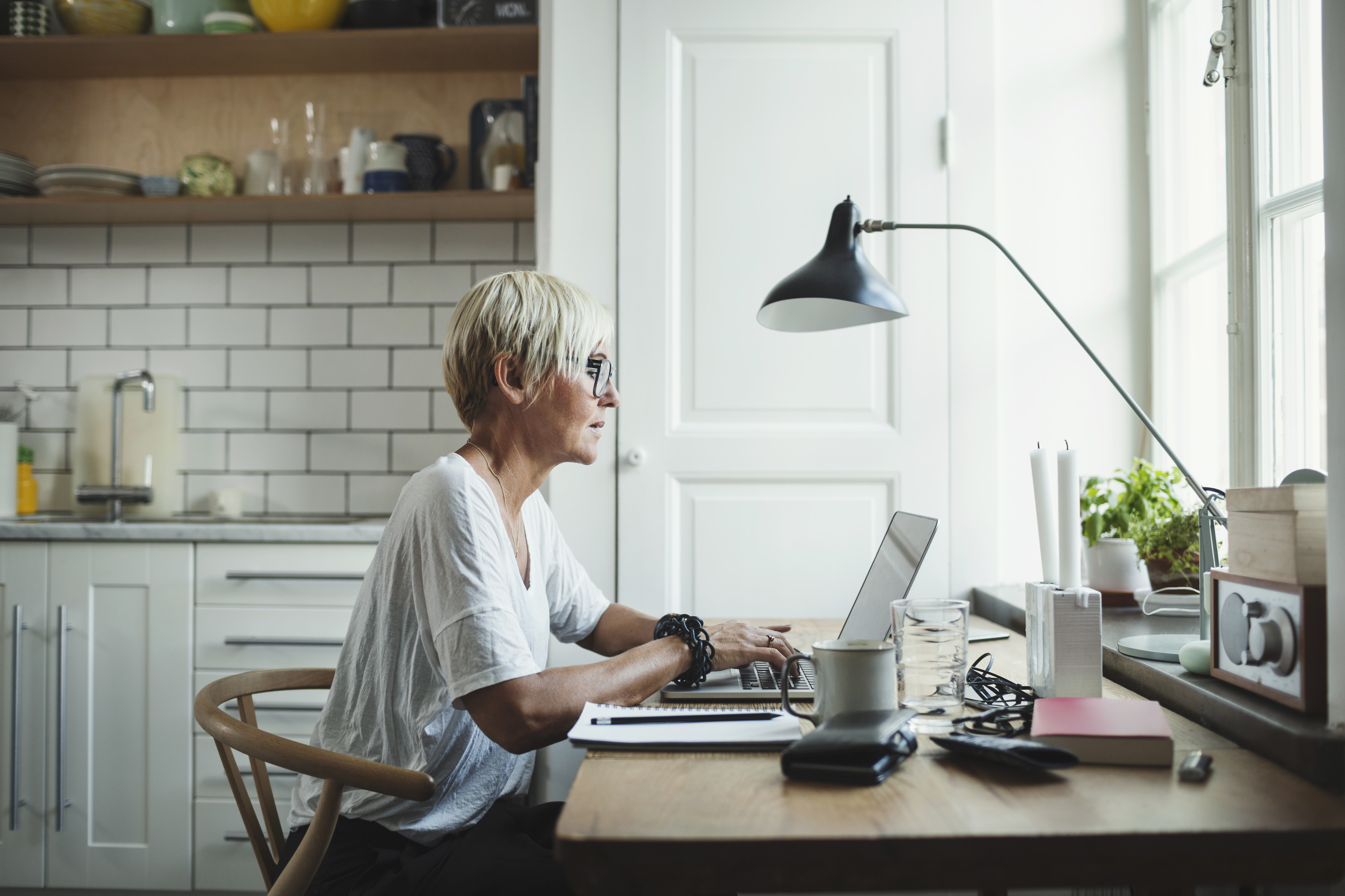 Side view of designer using laptop at home office