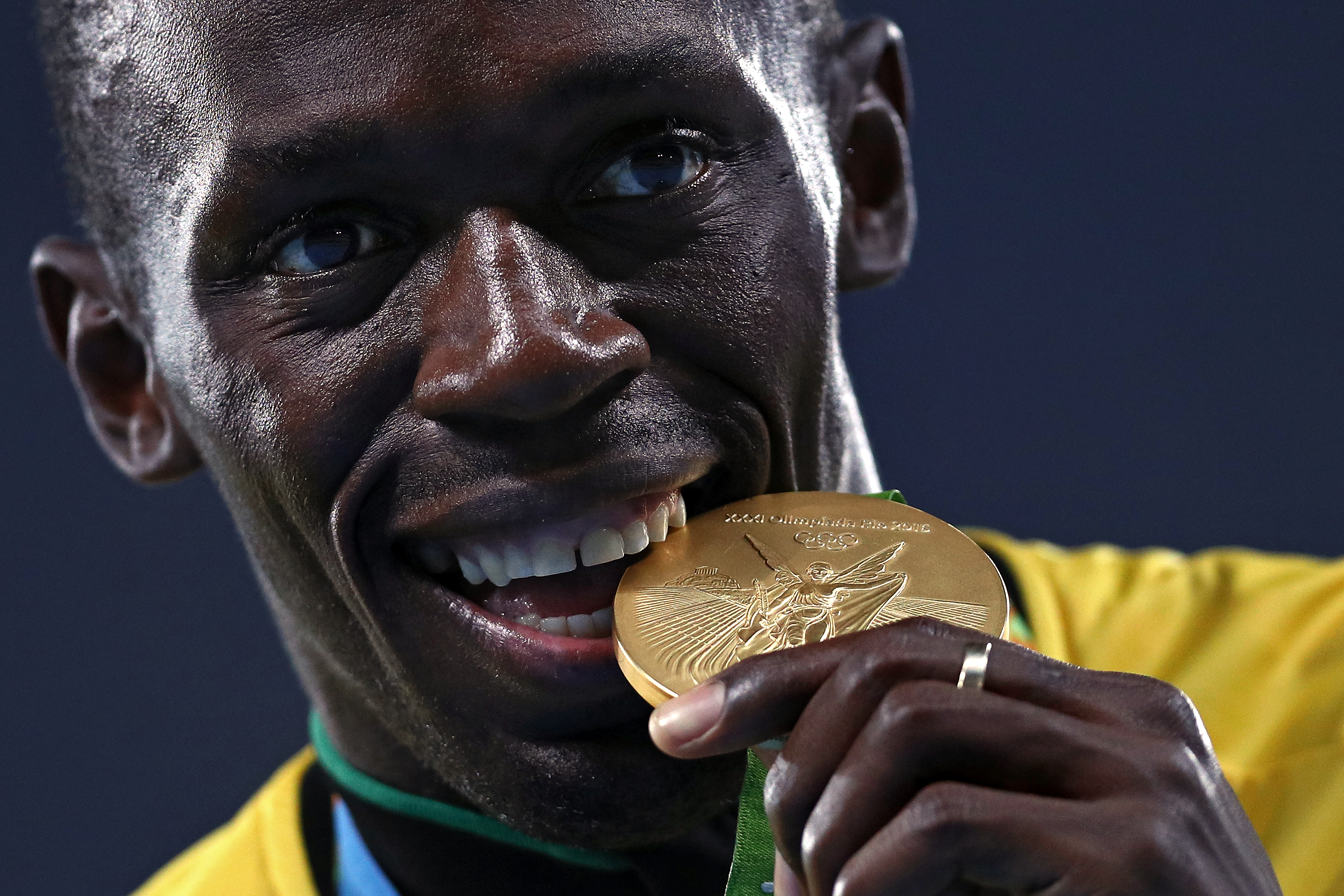 Usain Bolt bites his gold medal during the medal ceremony for the Men's 4 x 100 meter Relay on Day 15 of the Rio 2016 Olympic Games at the Olympic Stadium on Aug. 20, 2016 in Rio de Janeiro.