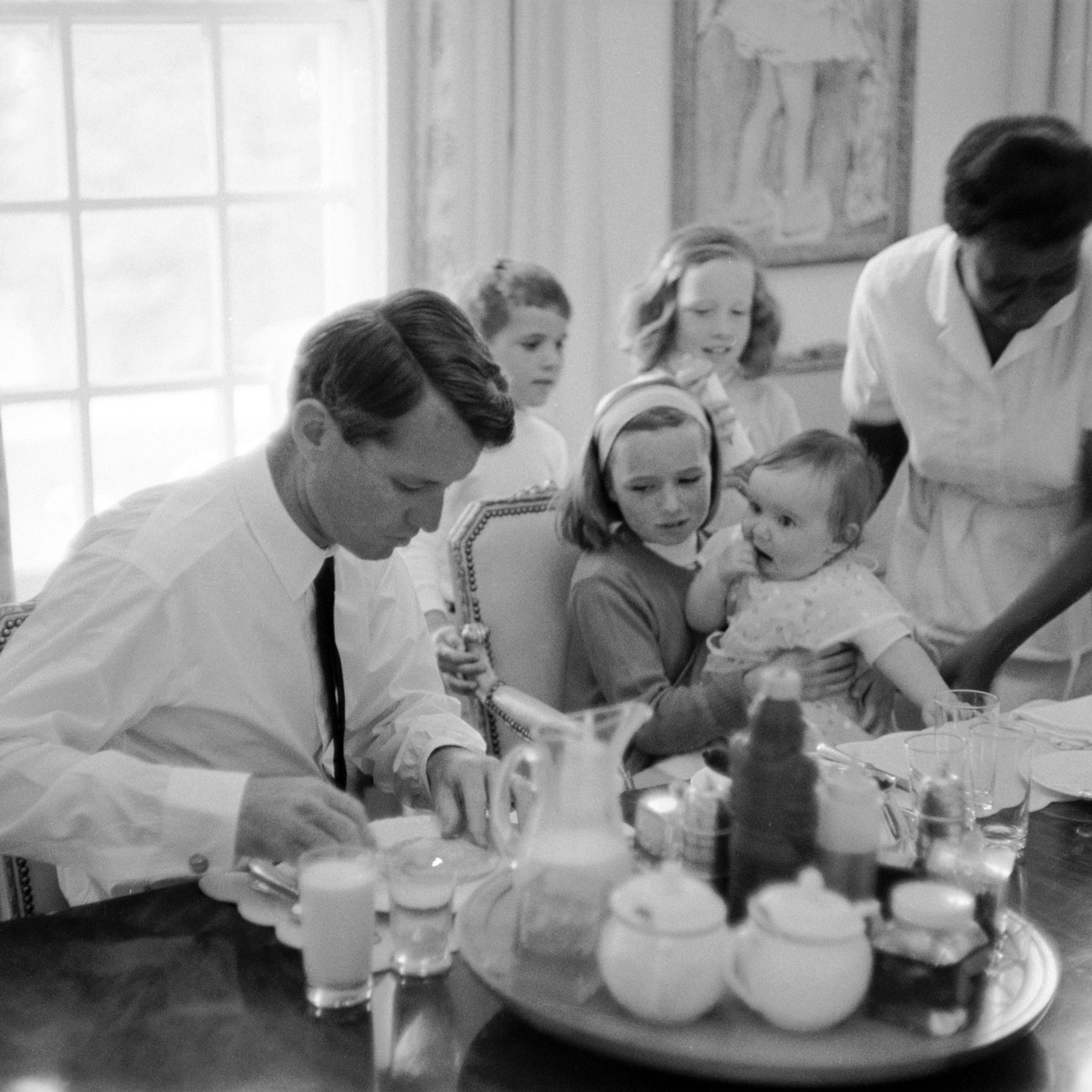 Robert F. Kennedy eats breakfast with his family, 1964.