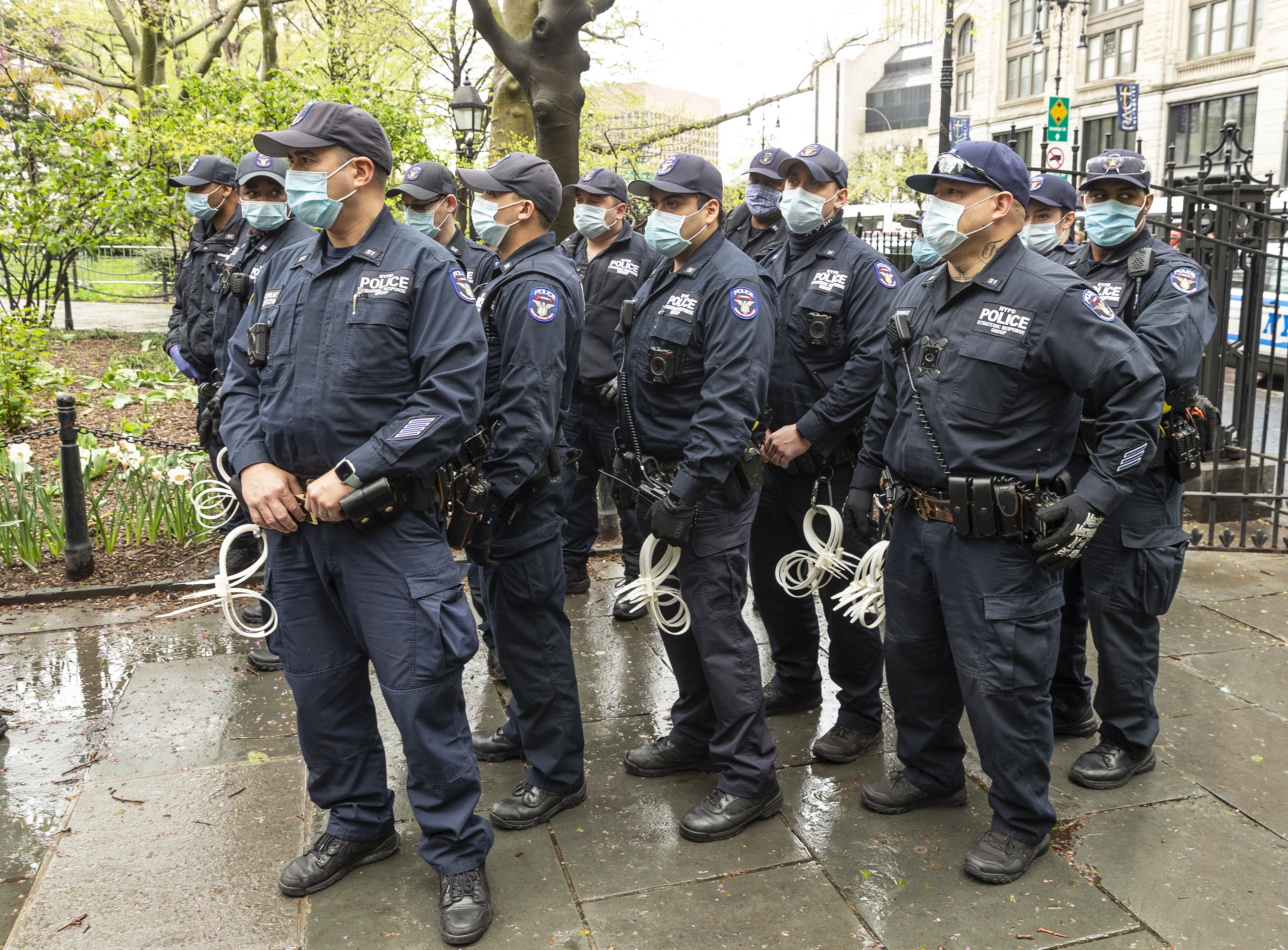 Police officers watching as activists hold small Make
