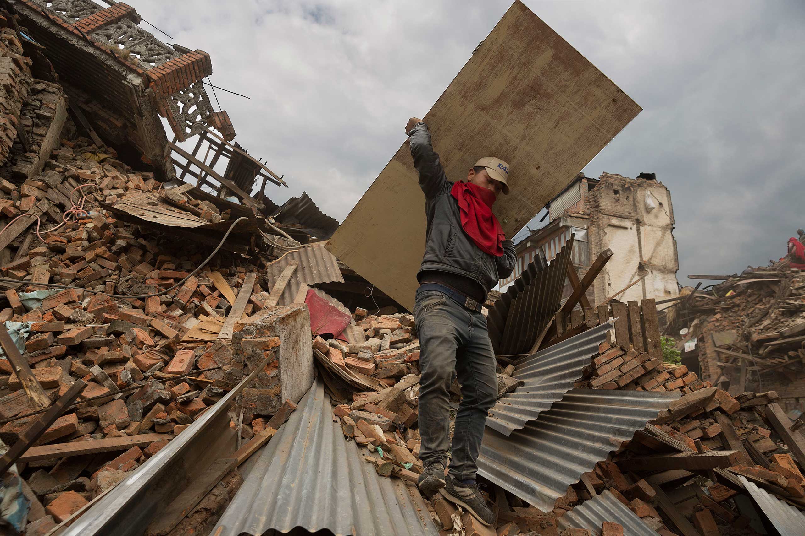 Nepal earthquake. Bhaktapur. A city near Katmandu. People reclaiming their possessions from the wreckage. A man who had been buried and died being pulled out of the wreckage by there Nepali Army rescue team. Sculpture of elephant in ruins of an ancient, 