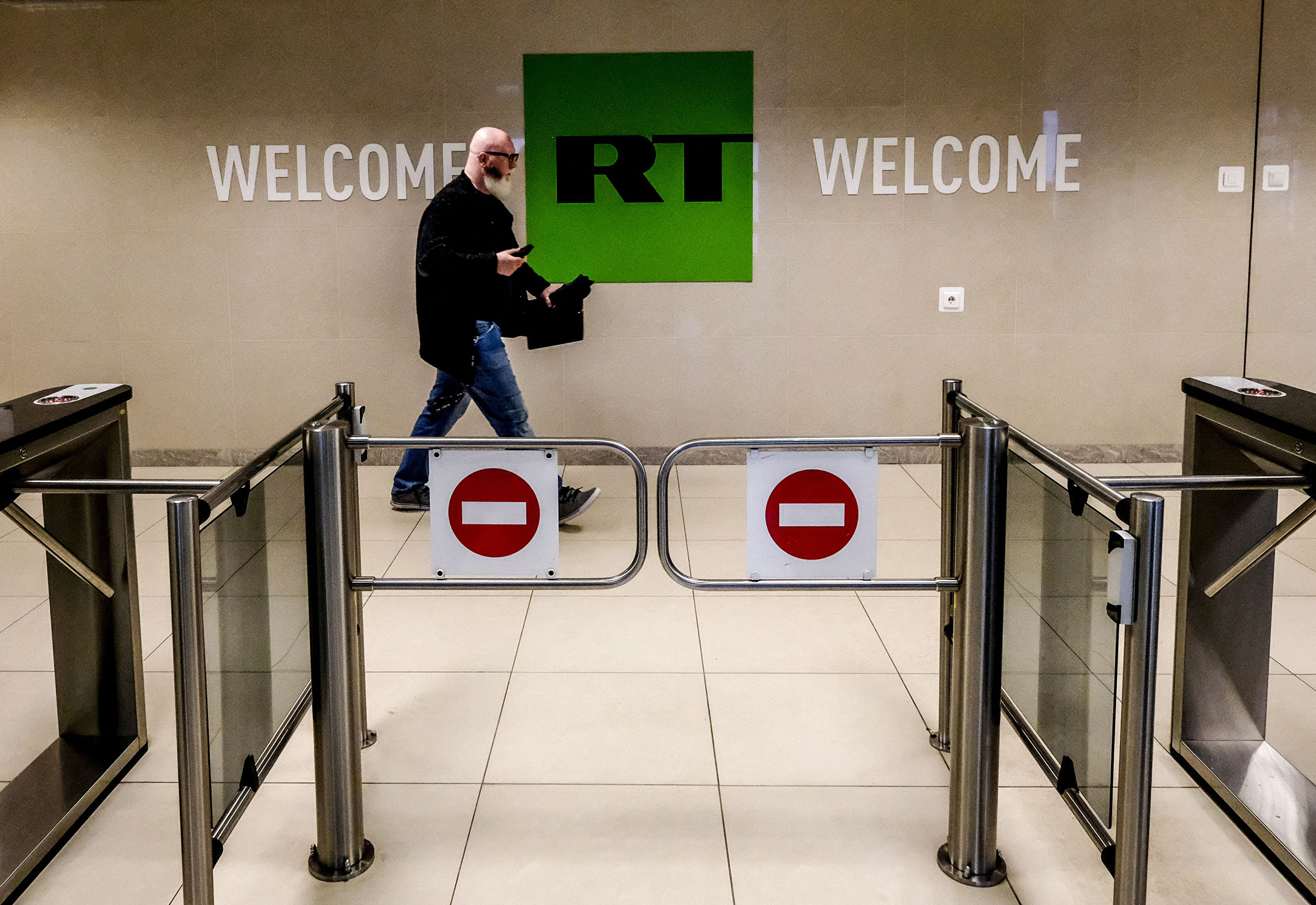 A man passes a control post of the Russia Today TV company in Moscow, June 2018. Russian state-controlled media outlets RT and Sputnik will be banned in the European Union, announced European Commission President Ursula von der Leyen in February 2022.
