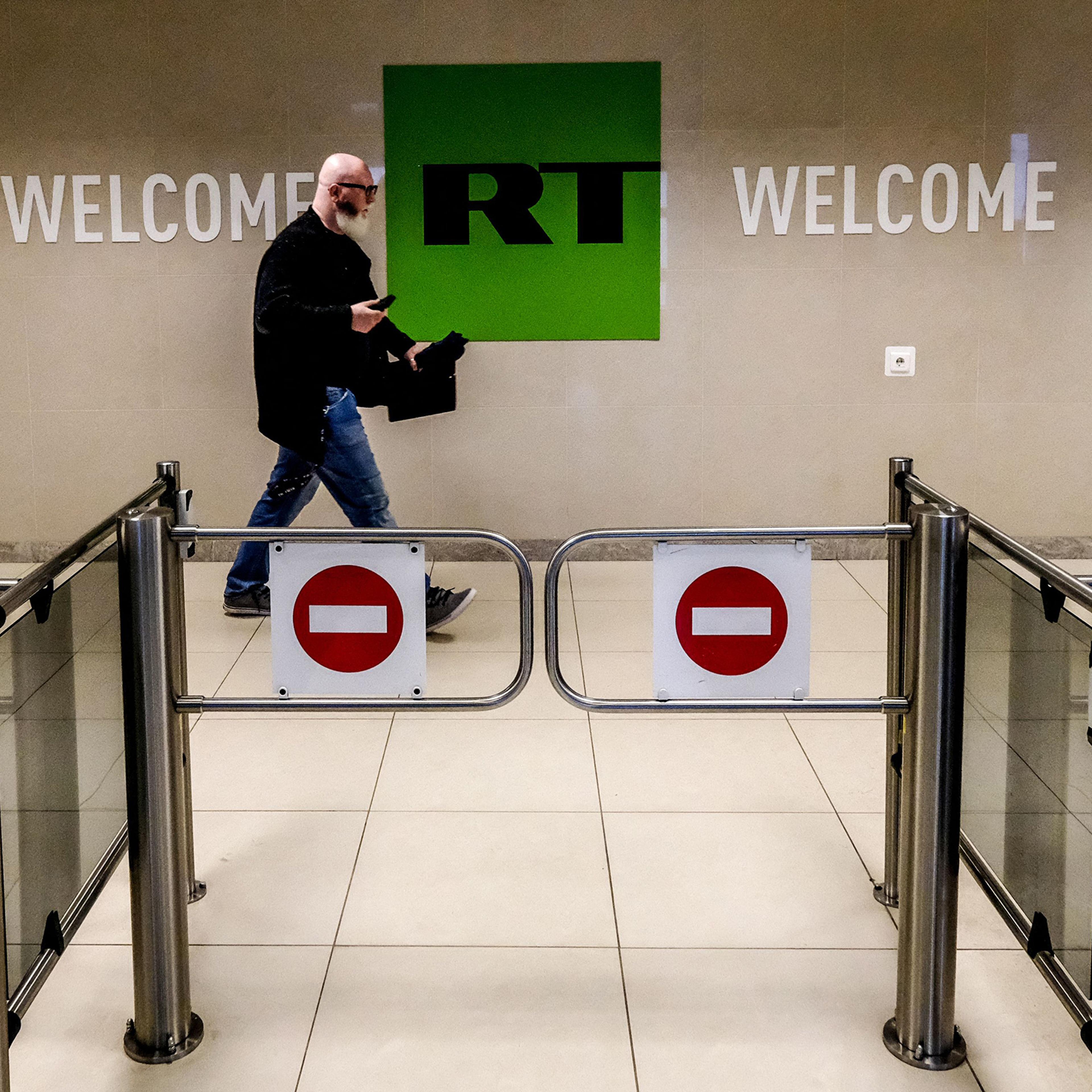 A man passes a control post of the Russia Today TV company in Moscow, June 2018. Russian state-controlled media outlets RT and Sputnik will be banned in the European Union, announced European Commission President Ursula von der Leyen in February 2022.