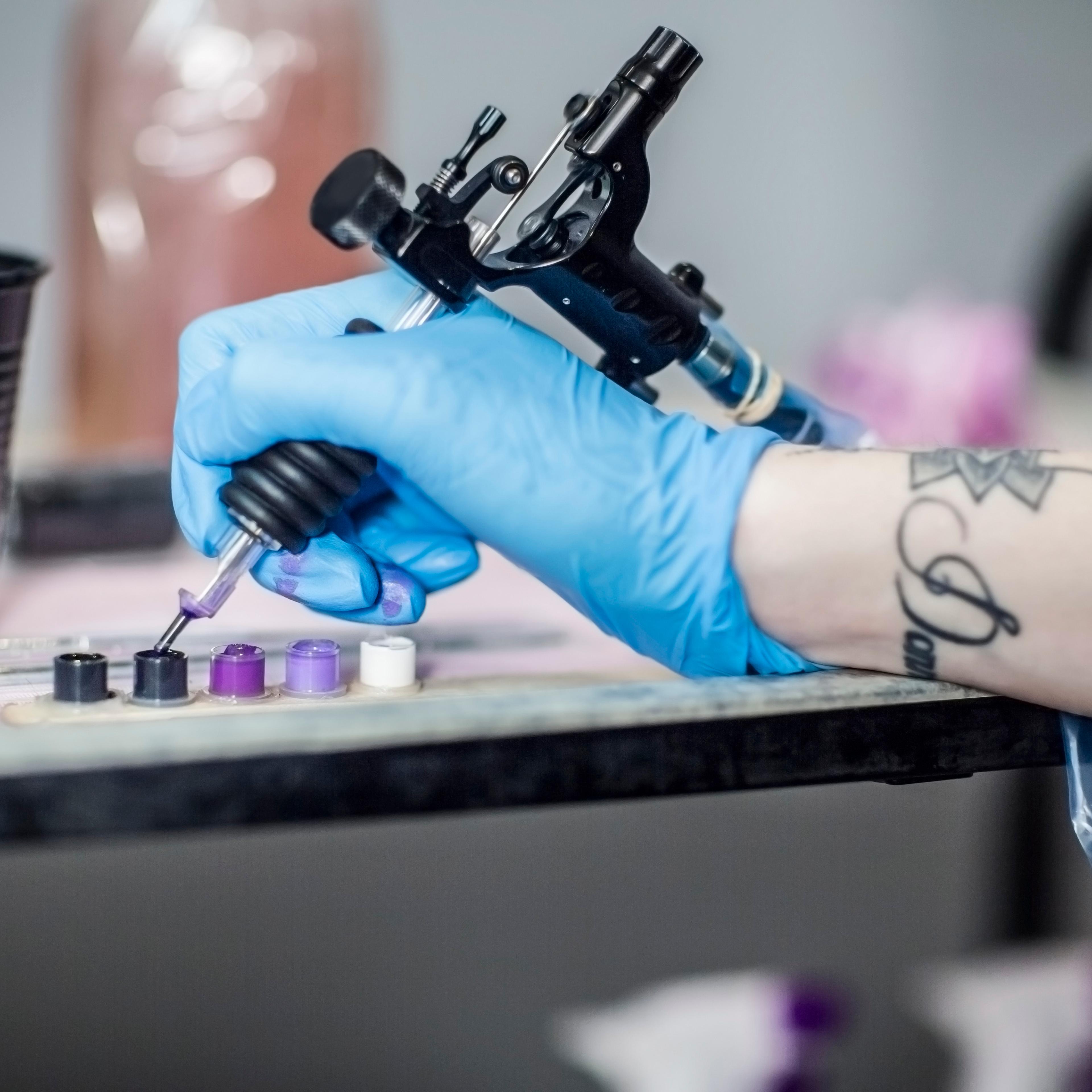 Tattoo artist in studio preparing