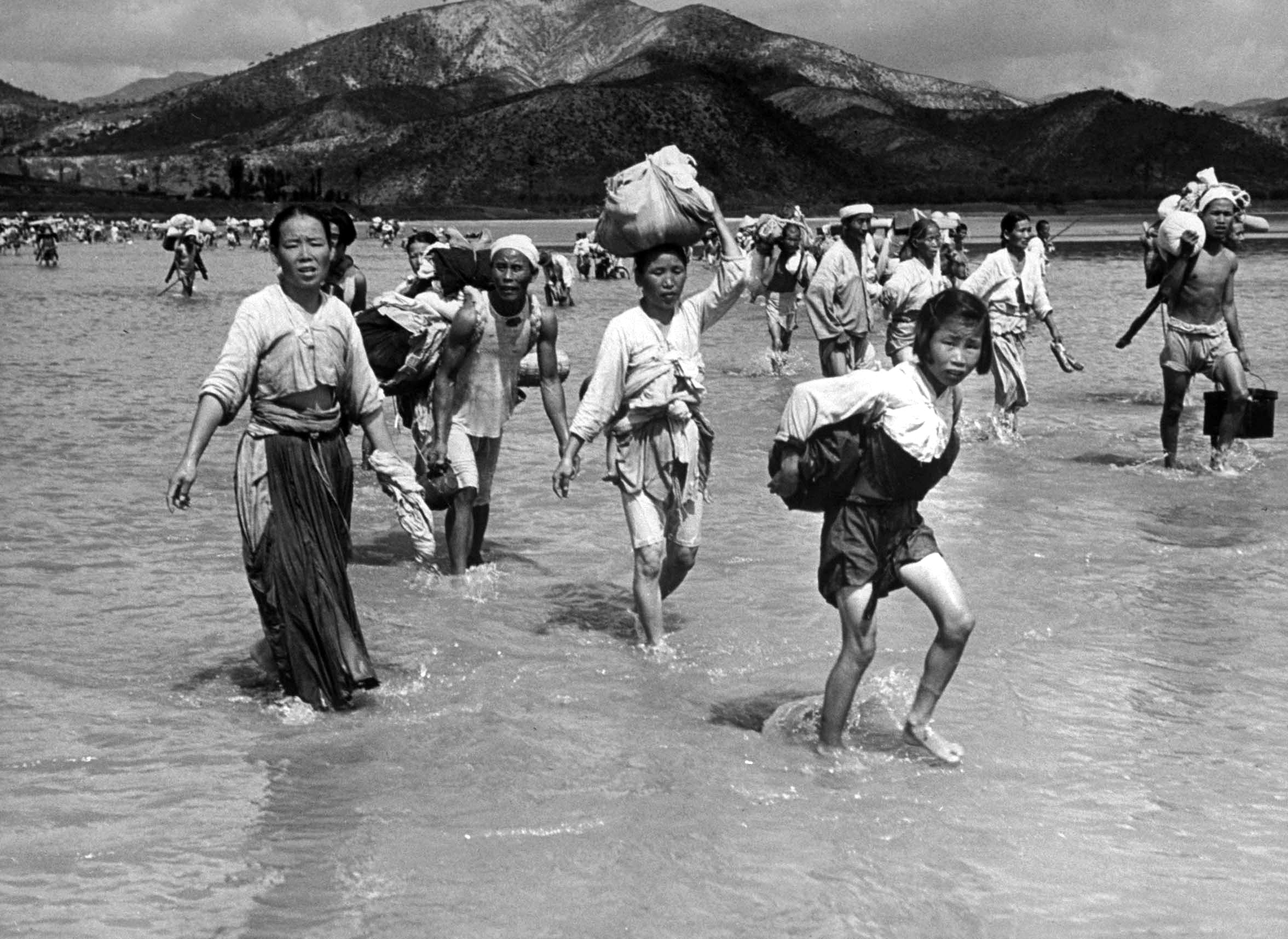 Korean refugees crossing the Naktong River during the Korean war, 1950.
