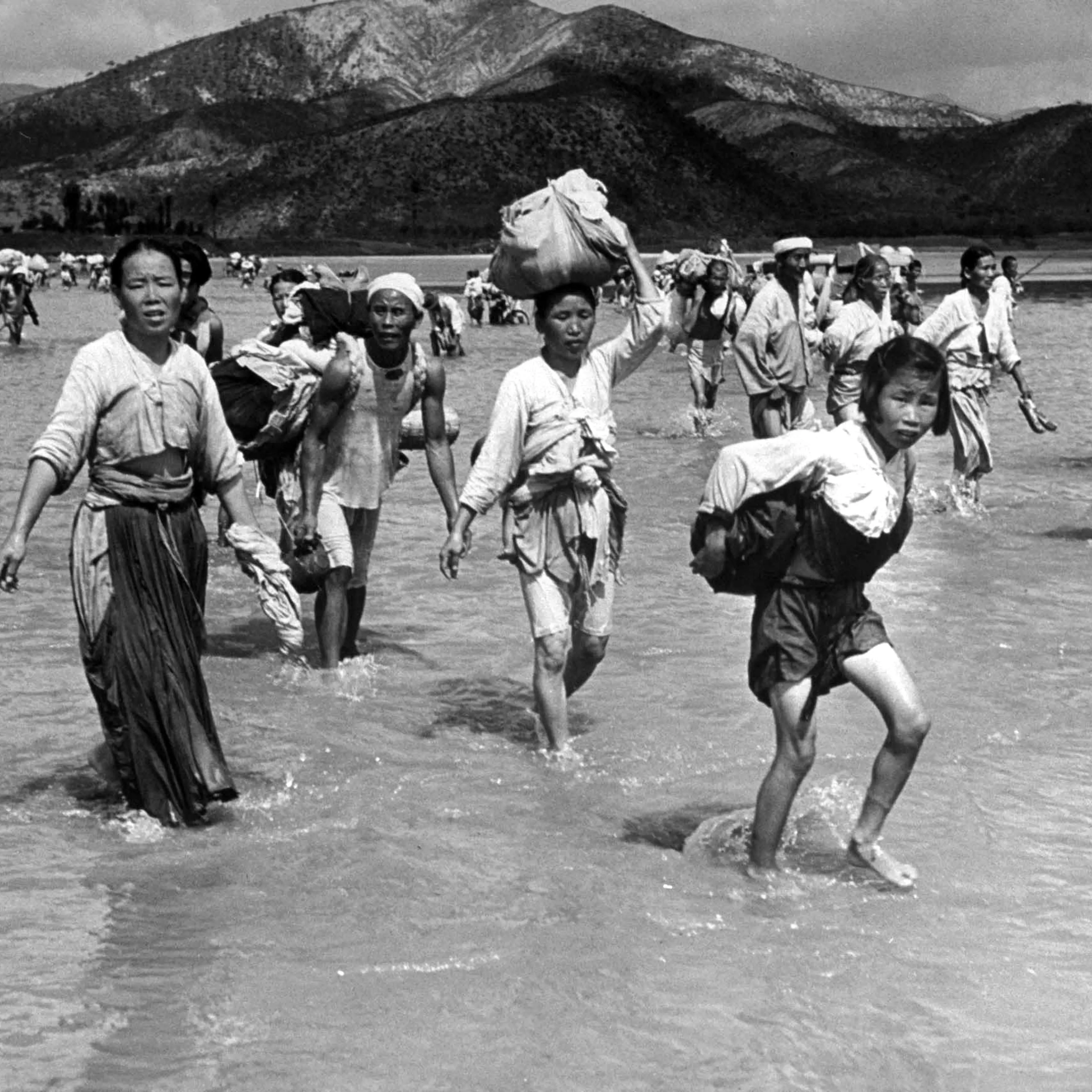 Korean refugees crossing the Naktong River during the Korean war, 1950.